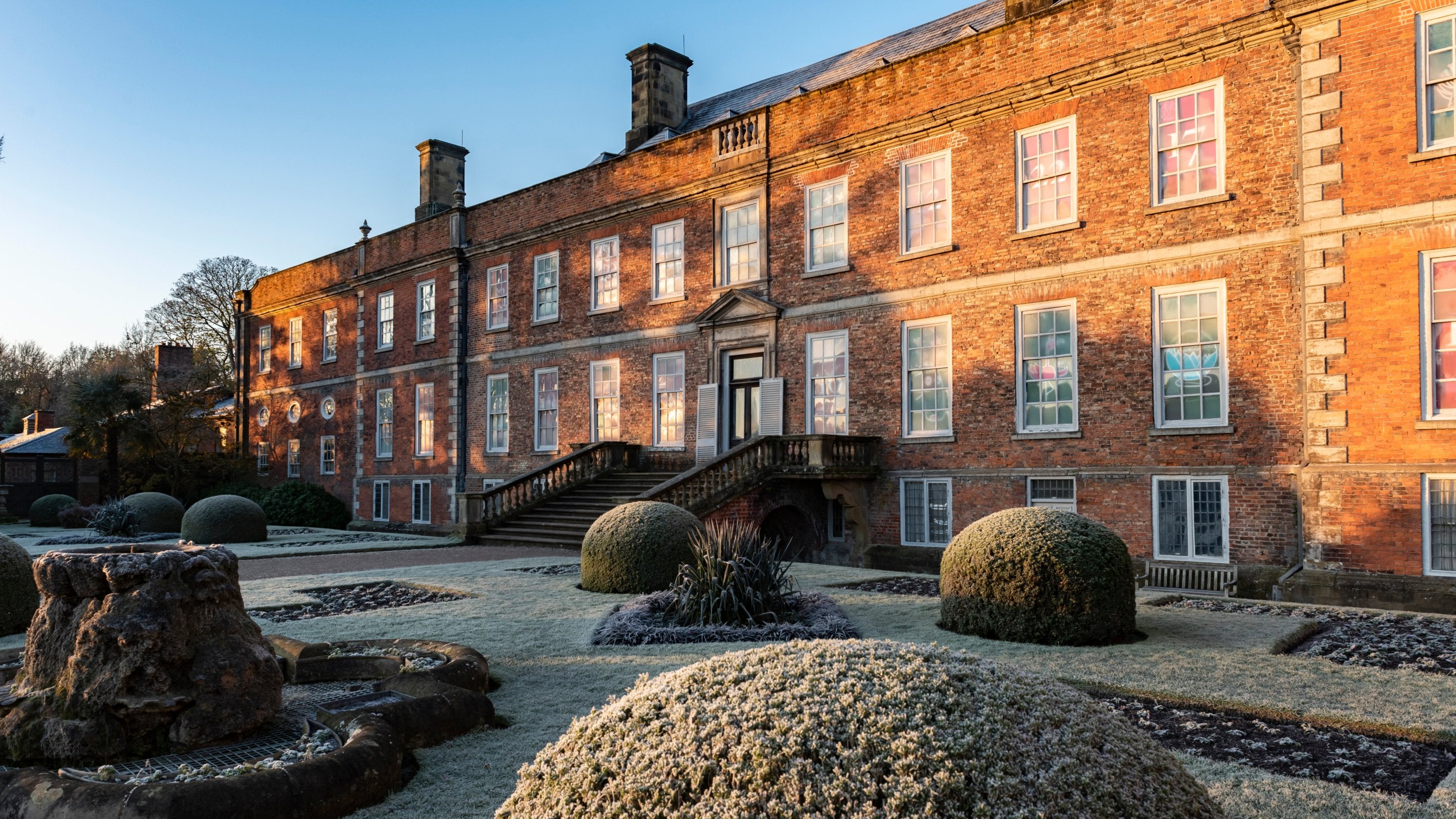 The house and topiary at Erddig, Wrexham covered in frost