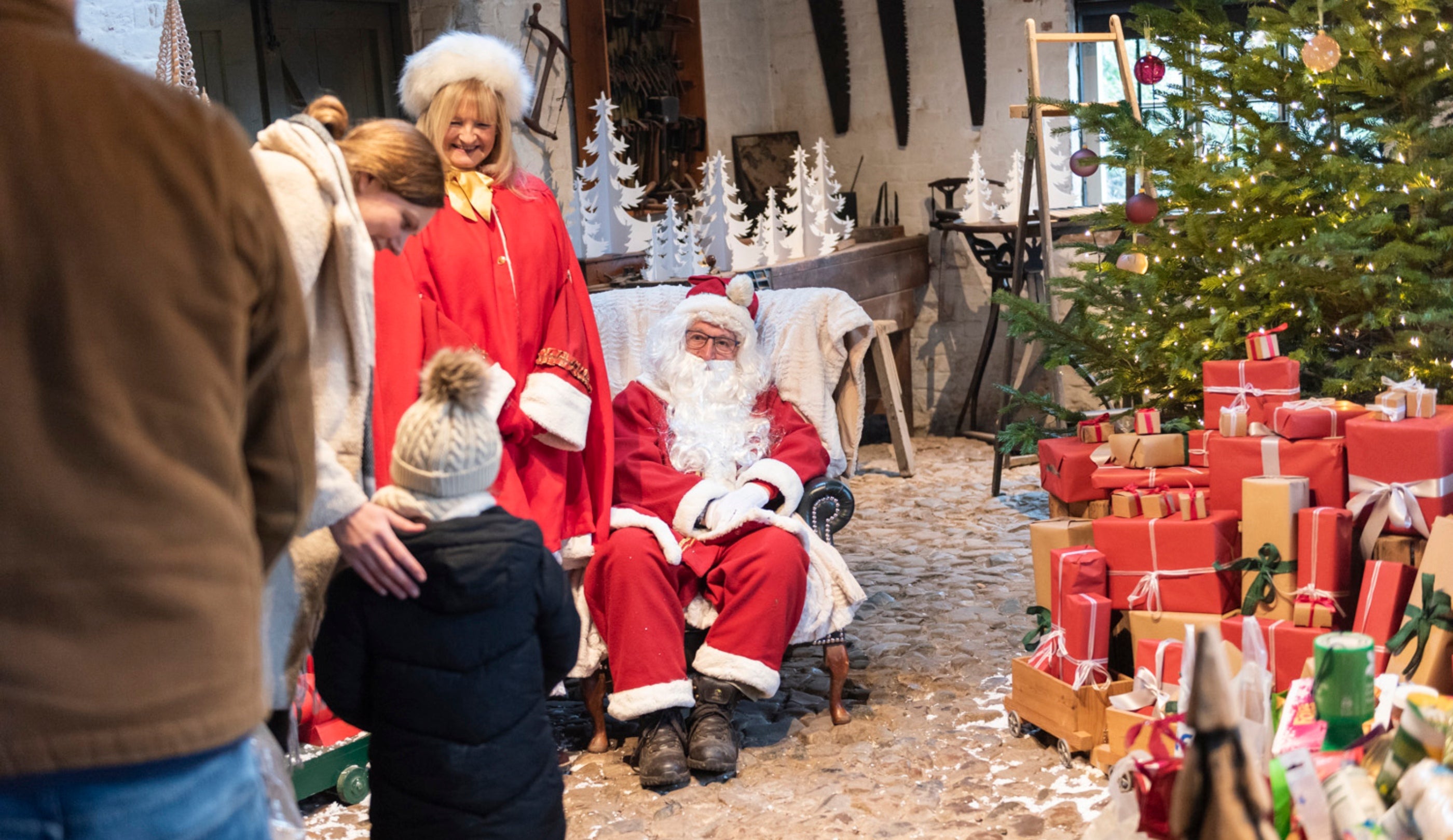 Father Christmas in his grotto at Erddig, surrounded by visitor’s donations to the local foodbank.