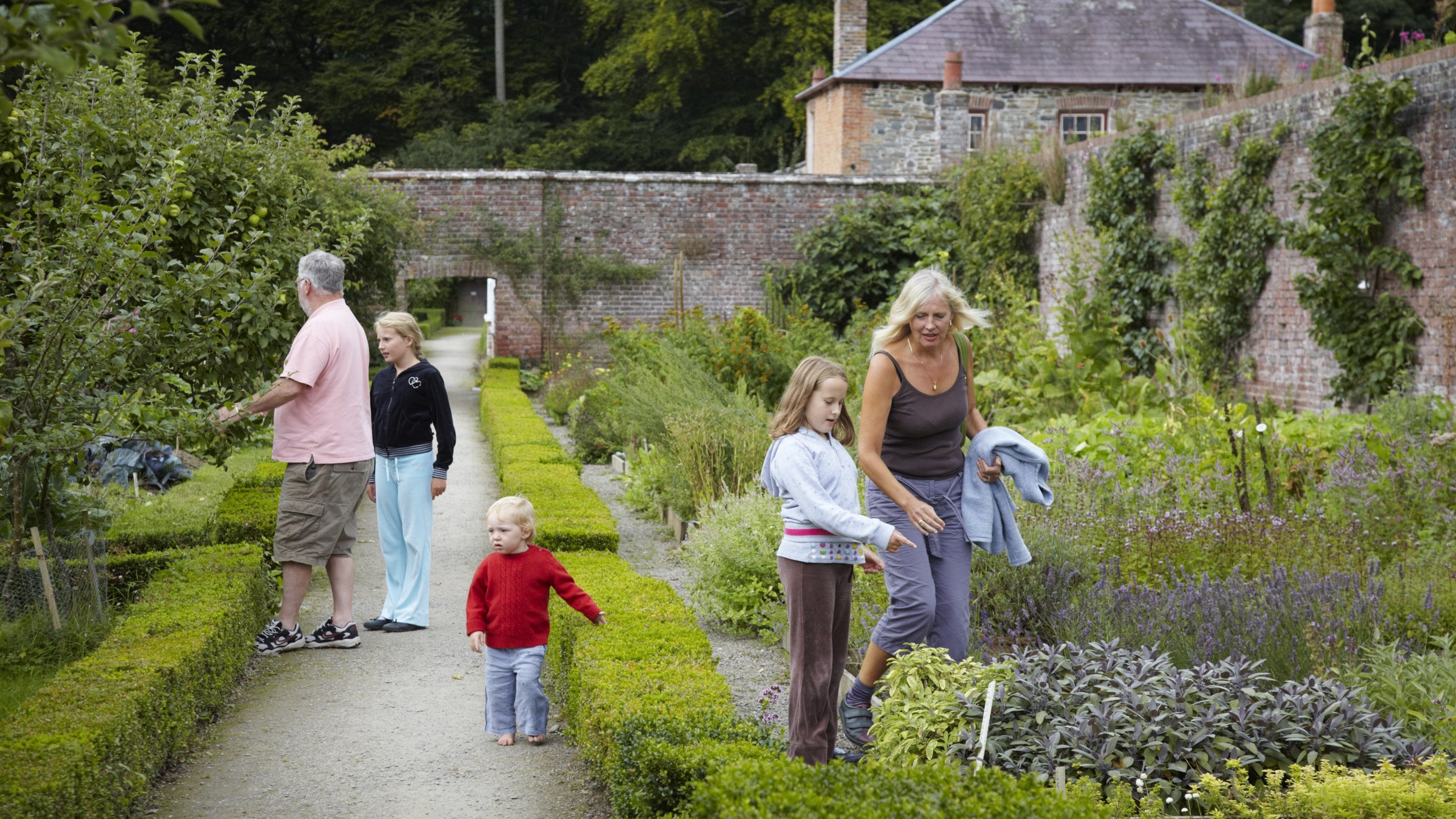 Visitors with children in the garden at Llanerchaeron in Ceredigion, Wales