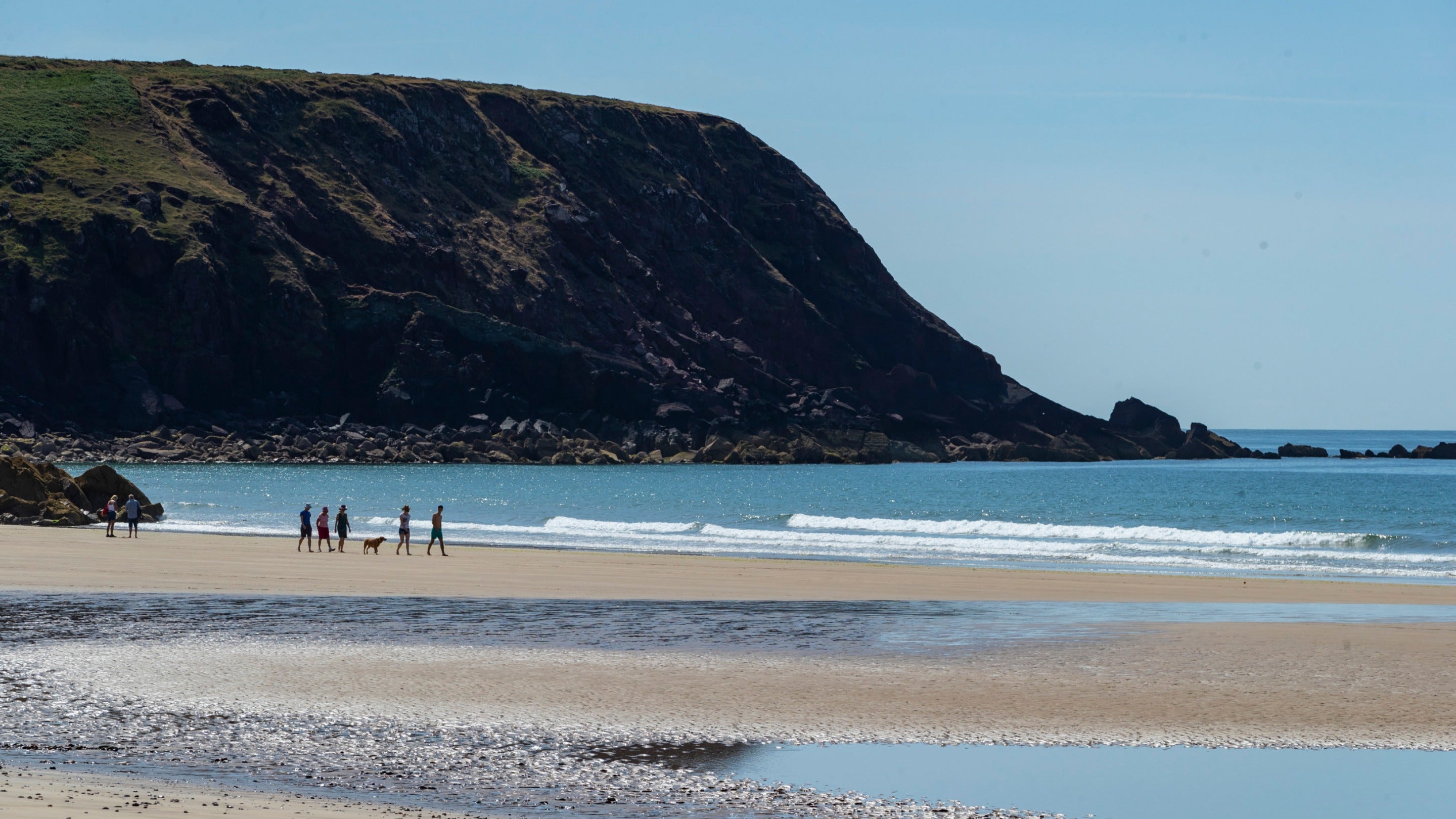 Visitors walking on the beach at Marloes Sands, Pembrokeshire