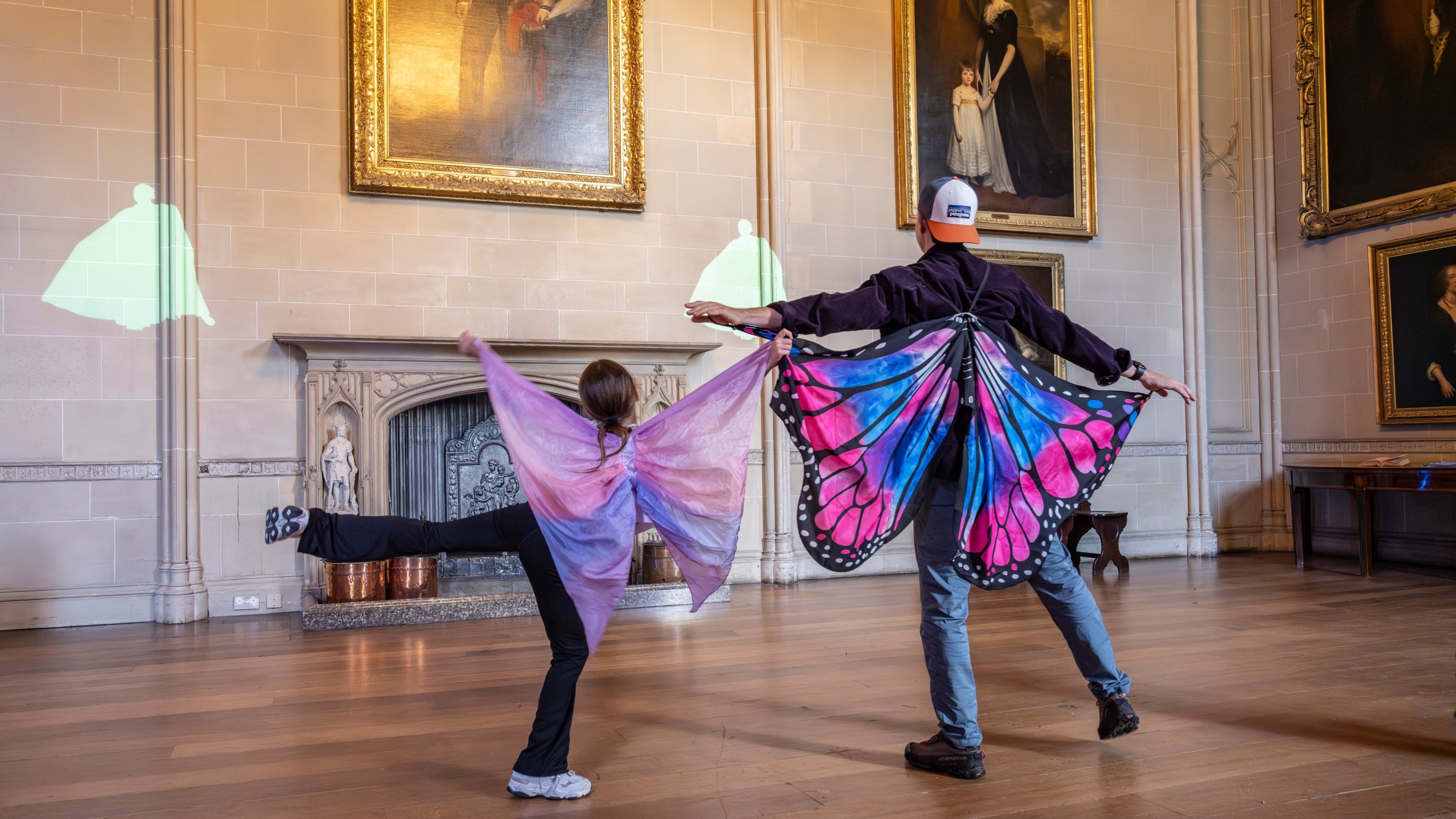 A family are in the Music Room at Plas Newydd, surrounded by art, dancing and dressing up in costumes inspired by the Dancing Marquess