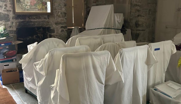 Items from the collections are covered with white sheets at Plas yn Rhiw
