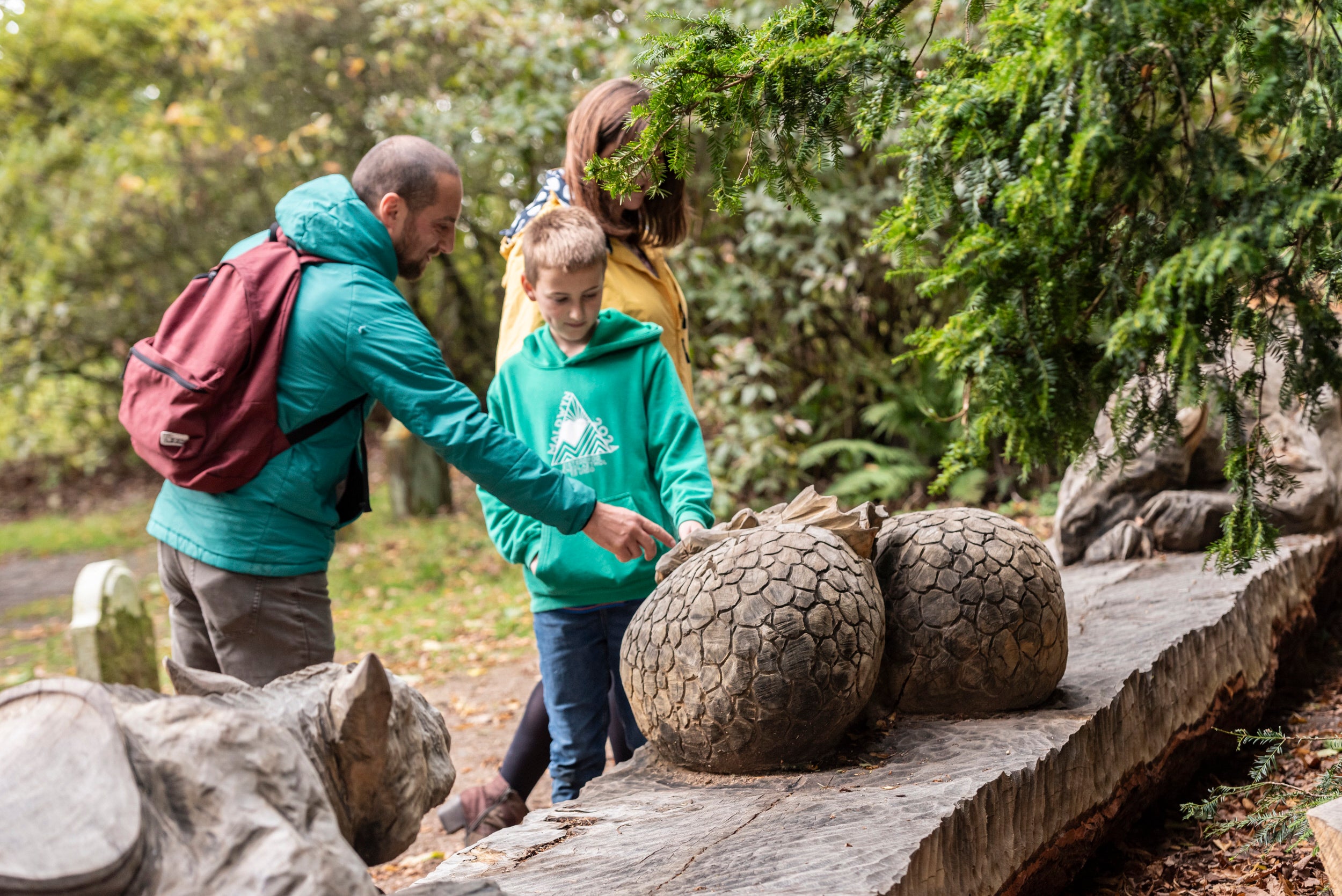 Visitors with the Wyvern sculpture by Simon O'Rourke at Powis Castle, Powys, Wales