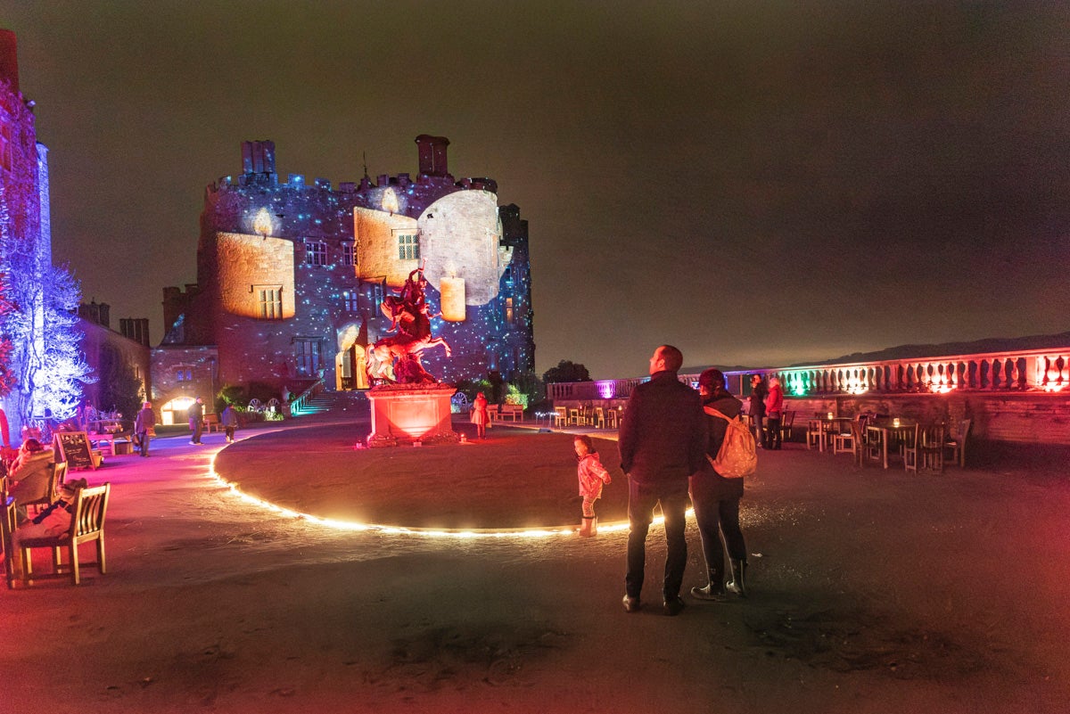 A family enjoying the Christmas illuminations at Powis Castle and Garden