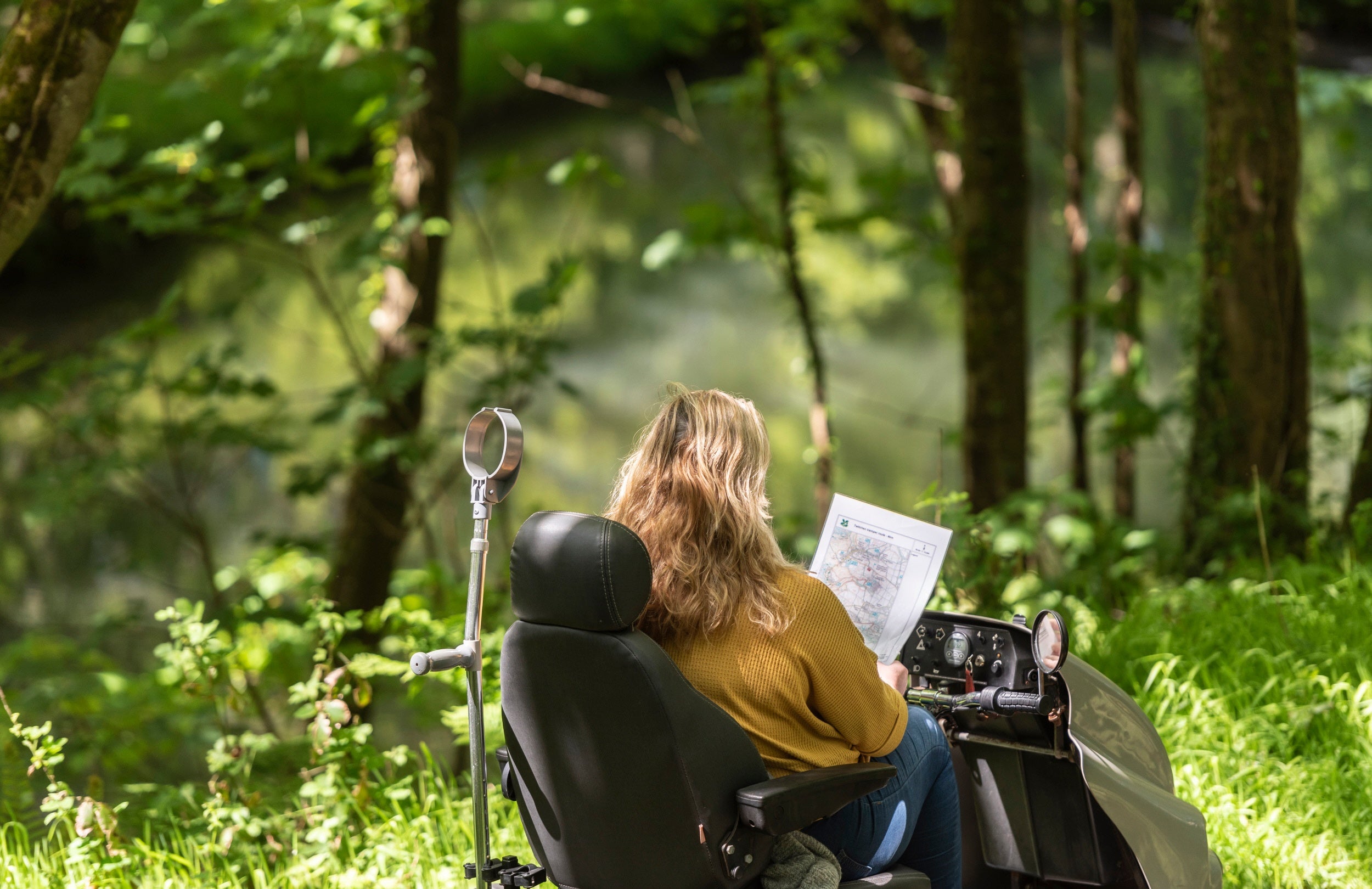 Somebody exploring the accessible path at Woolacombe via a mobility scooter