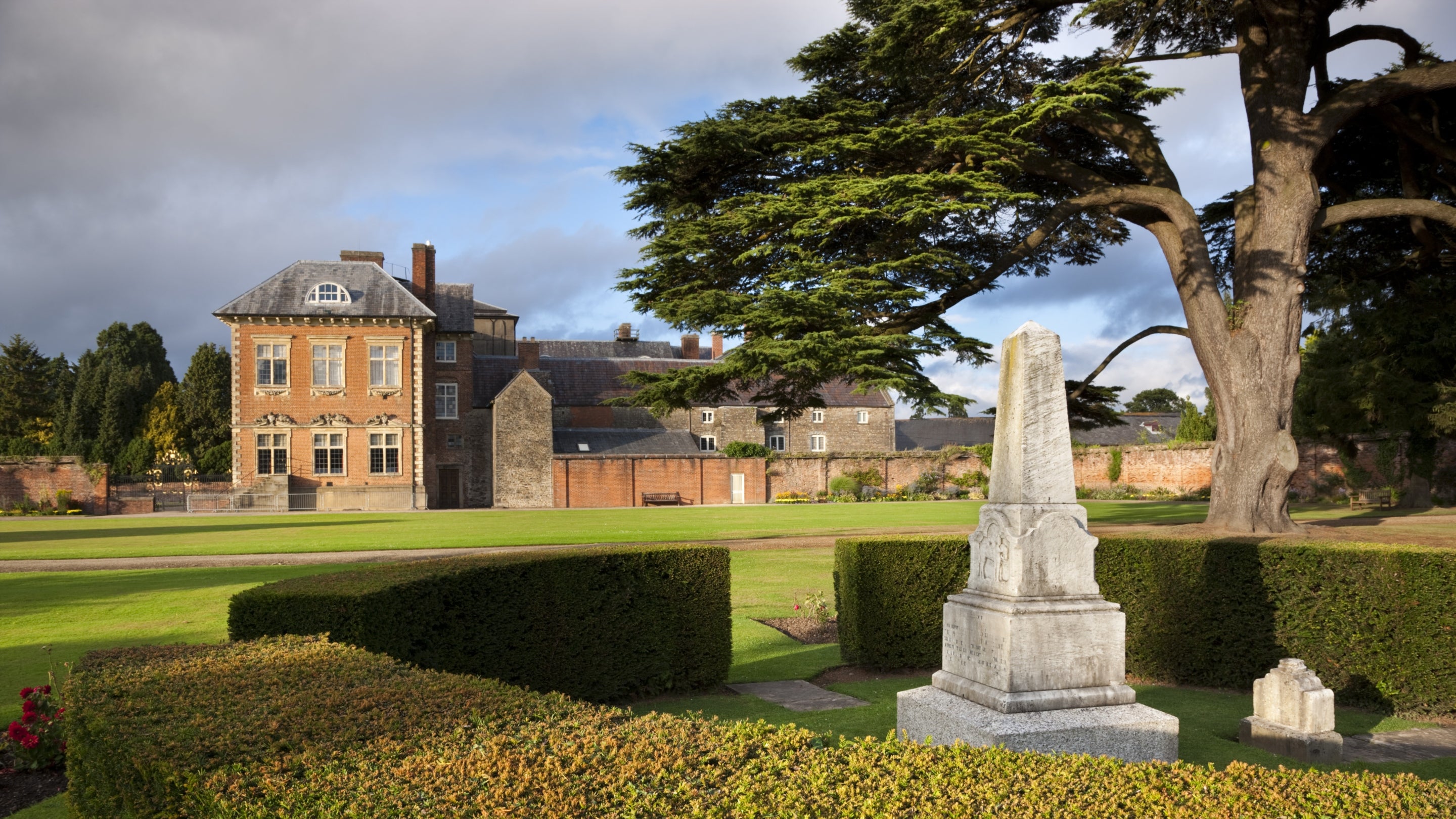 A view of the mansion house from the cedar garden, with Sir Briggs' stone obelisk in the foreground