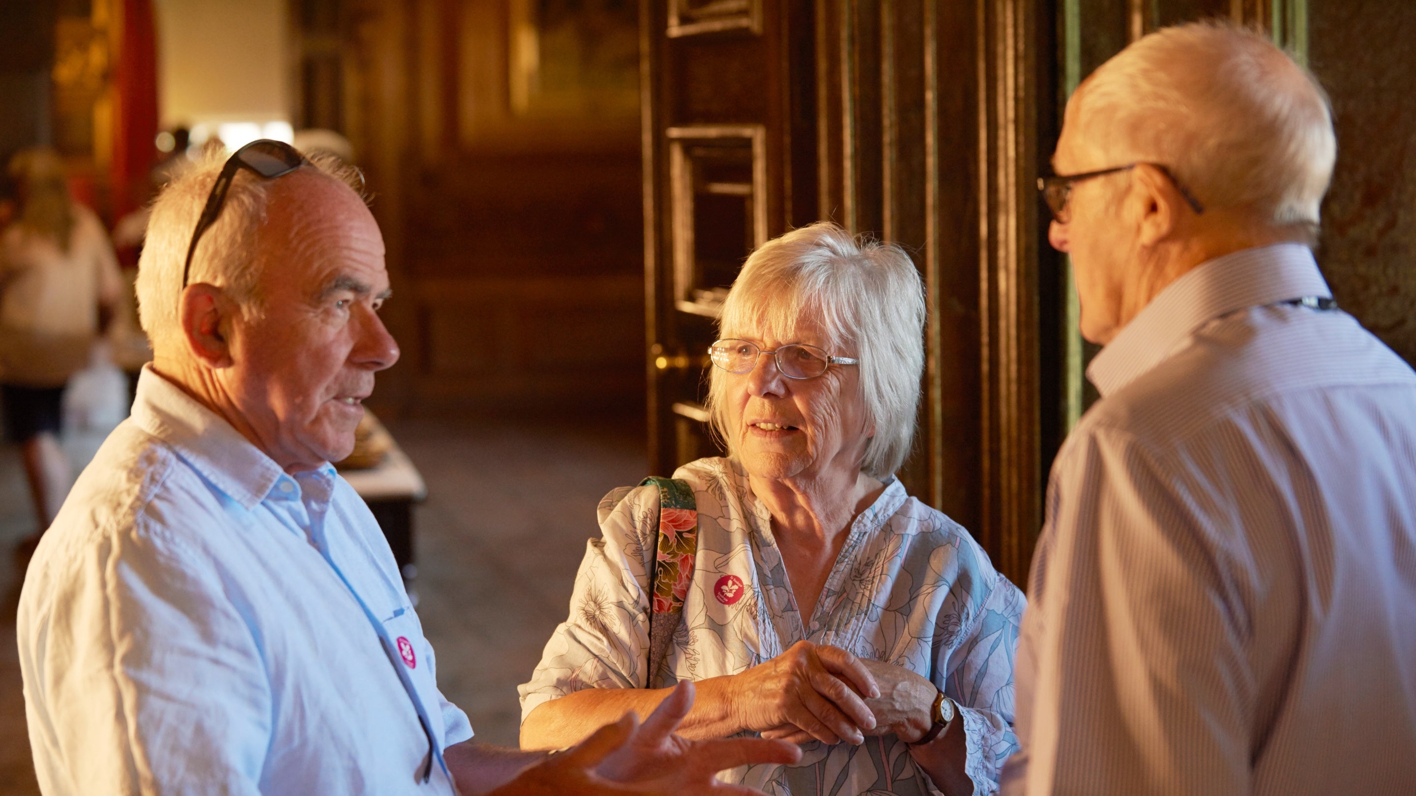 Volunteer room guide speaking with visitors at Tredegar House, Wales