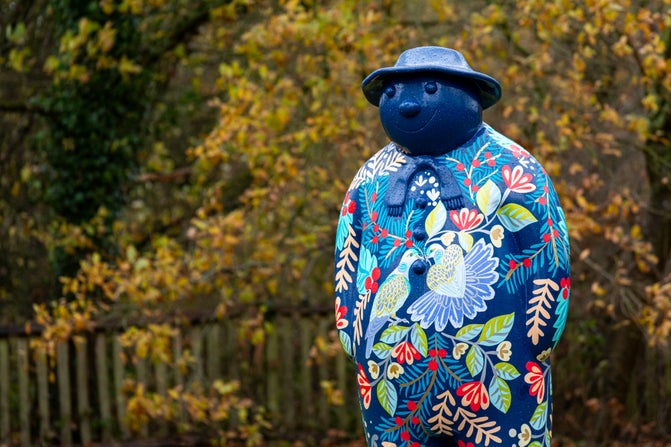 A mainly blue Snowman™ standing in the gardens at Baddesley Clinton, Warwickshire
