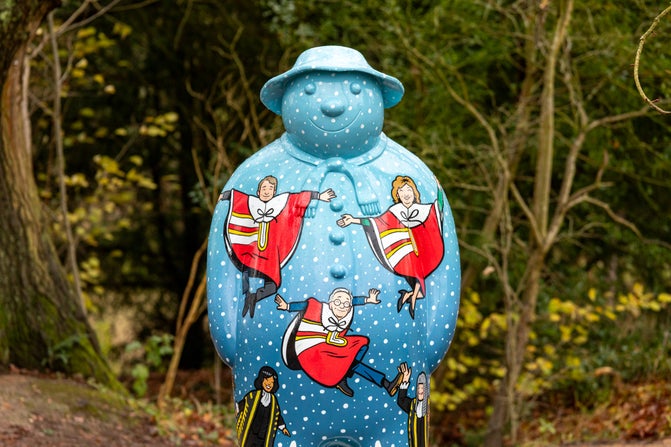 Pale blue and covered with white spots, this Snowman™ statue at Baddesley Clinton, Warwickshire, features several leaping lords
