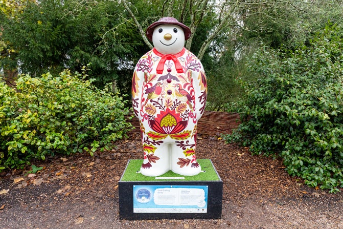 A very colourful Snowman™ smiles at you in the garden at Baddesley Clinton, Warwickshire