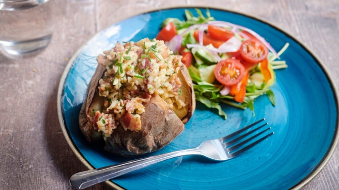 A baked potato filled with cheese and bacon, available from Packwood House, Warwickshire