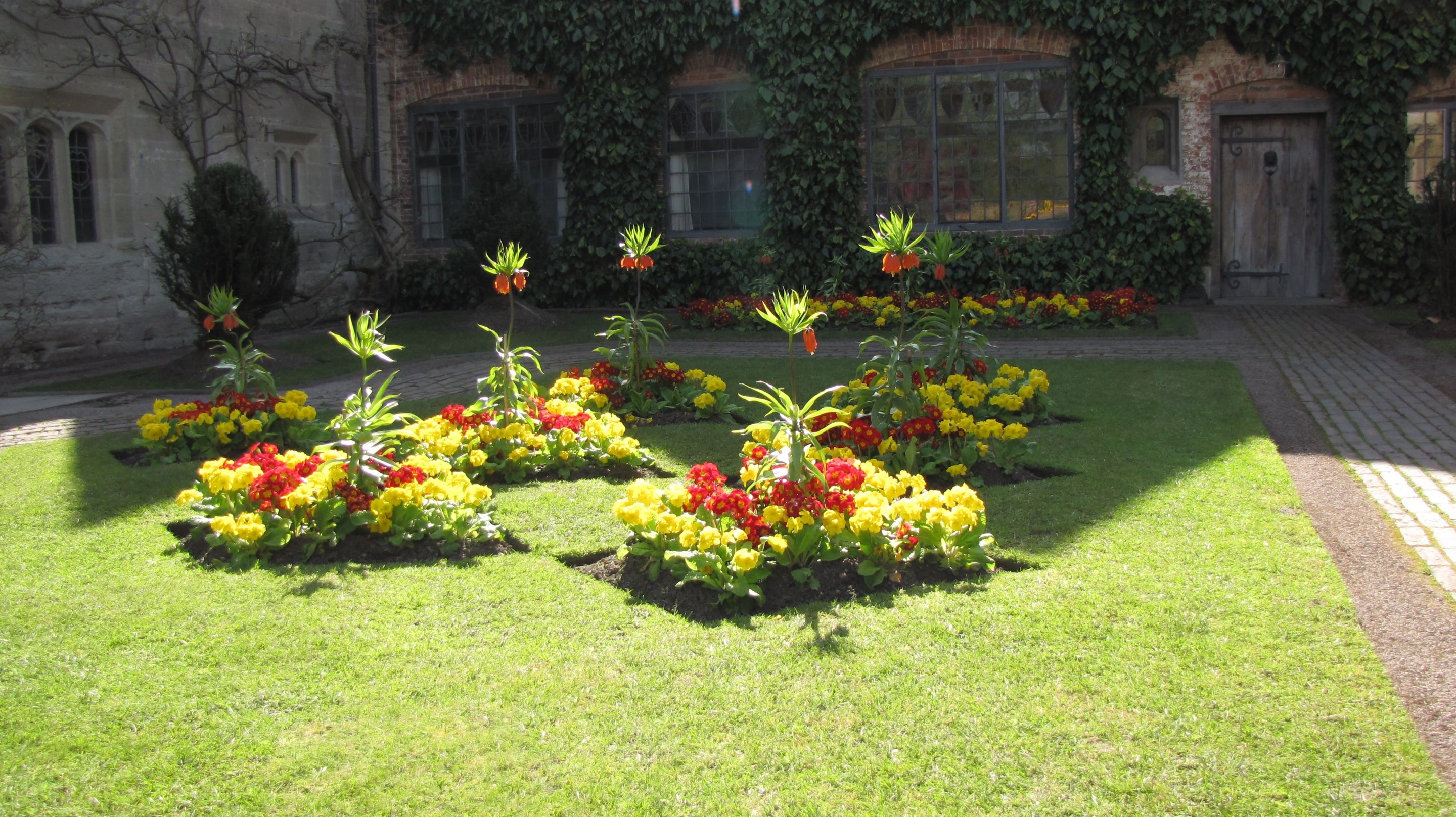 Springtime in the courtyard garden at Baddesley Clinton, Warwickshire