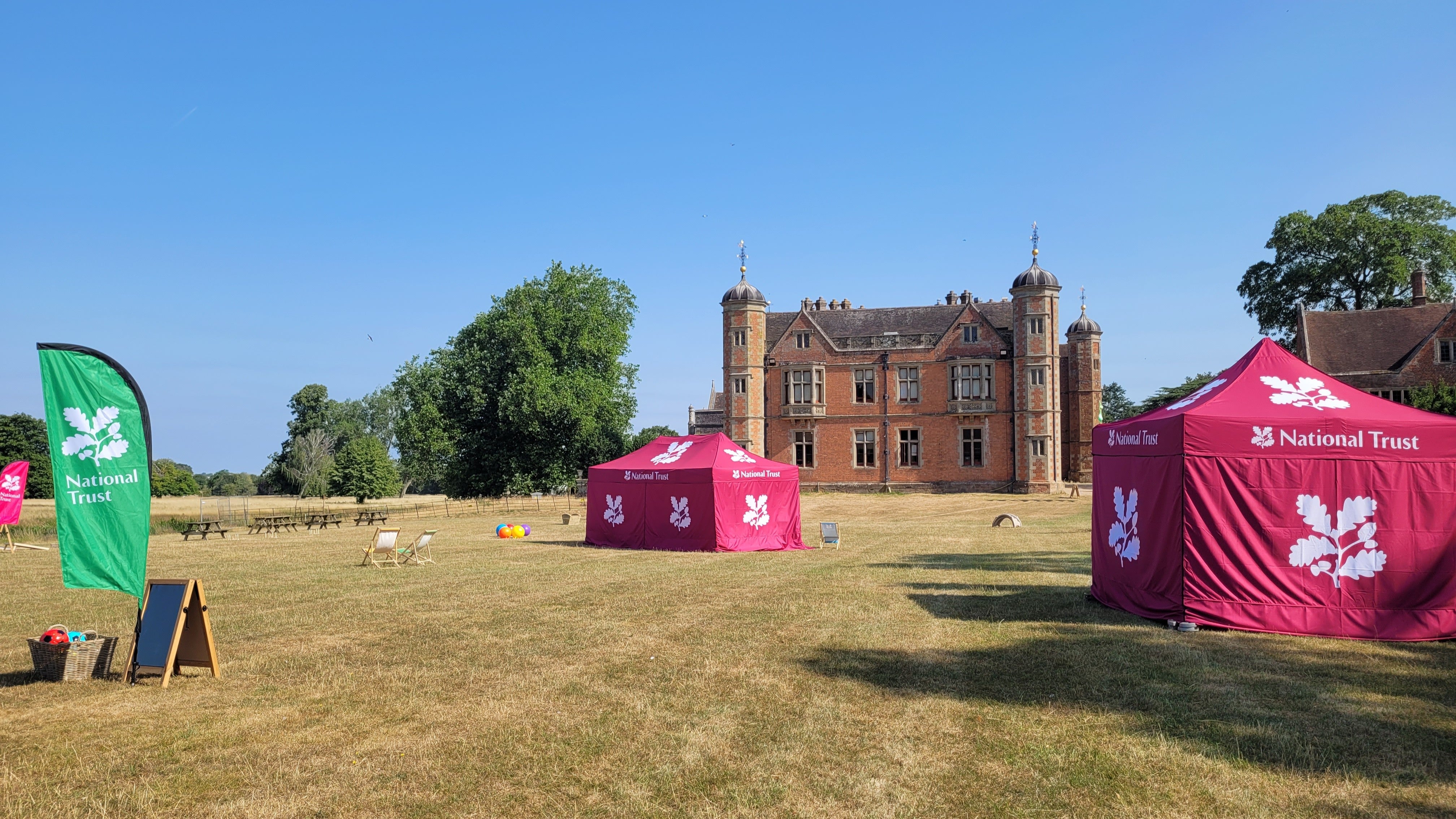 View of Charlecote House and the Paddock with marquees and games for the Summer of Play