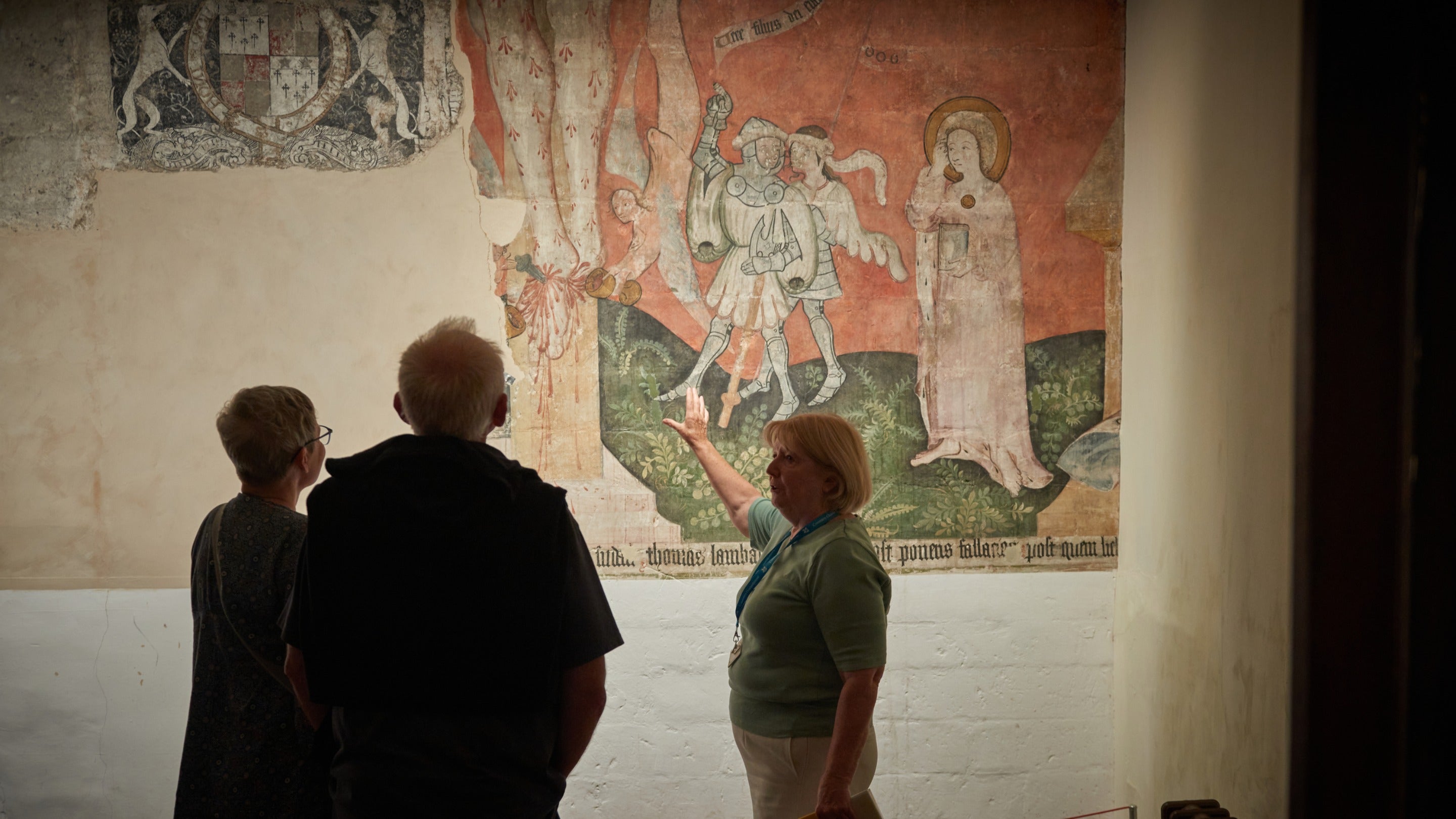Visitors looking at the Tudor murals in the monastery at Charterhouse