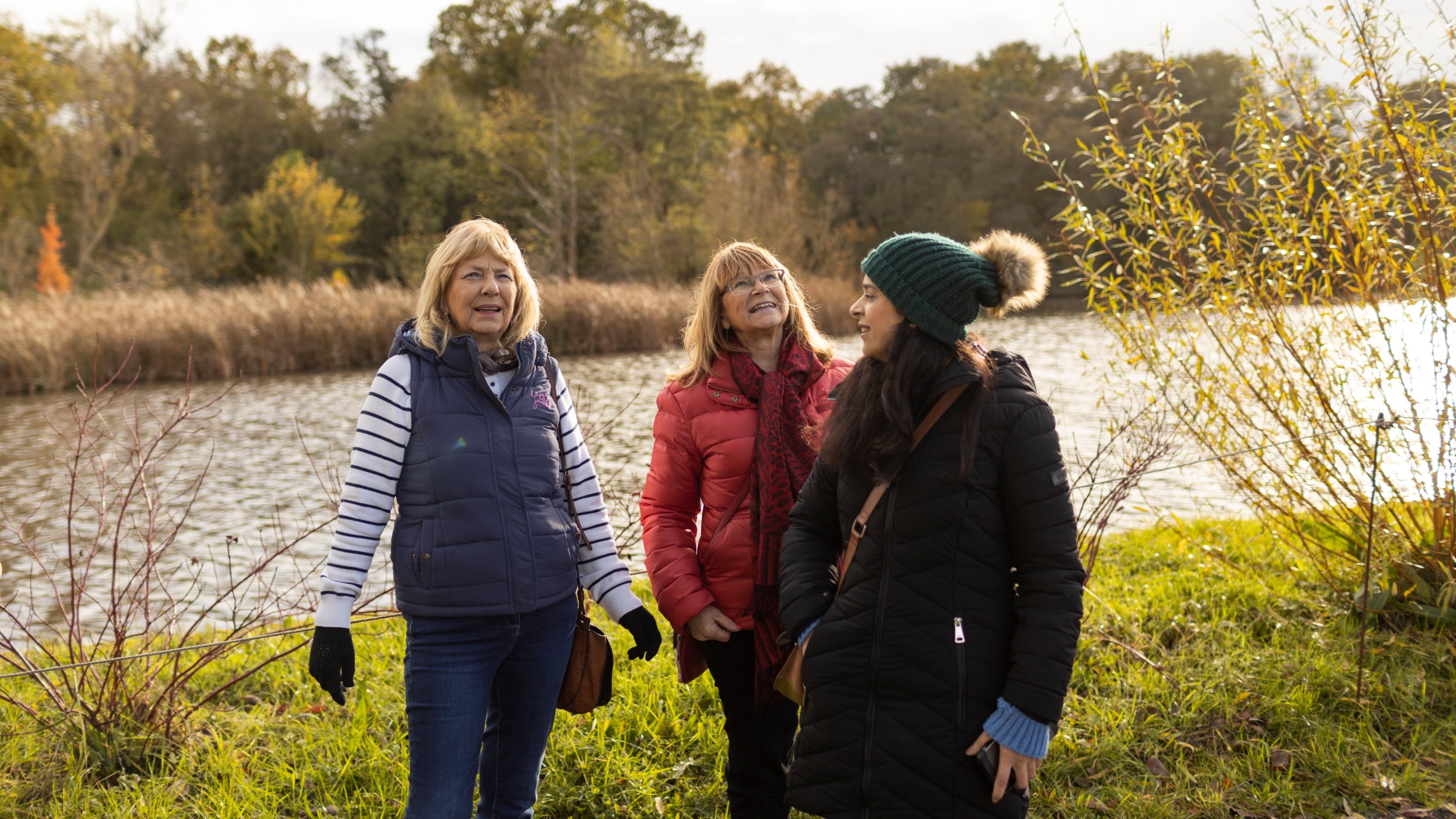 Three ladies exploring the gardens in November at Packwood House, Warwickshire