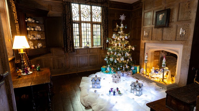 A Christmas tree at Packwood House, Warwickshire, surrounded by a snowy scene