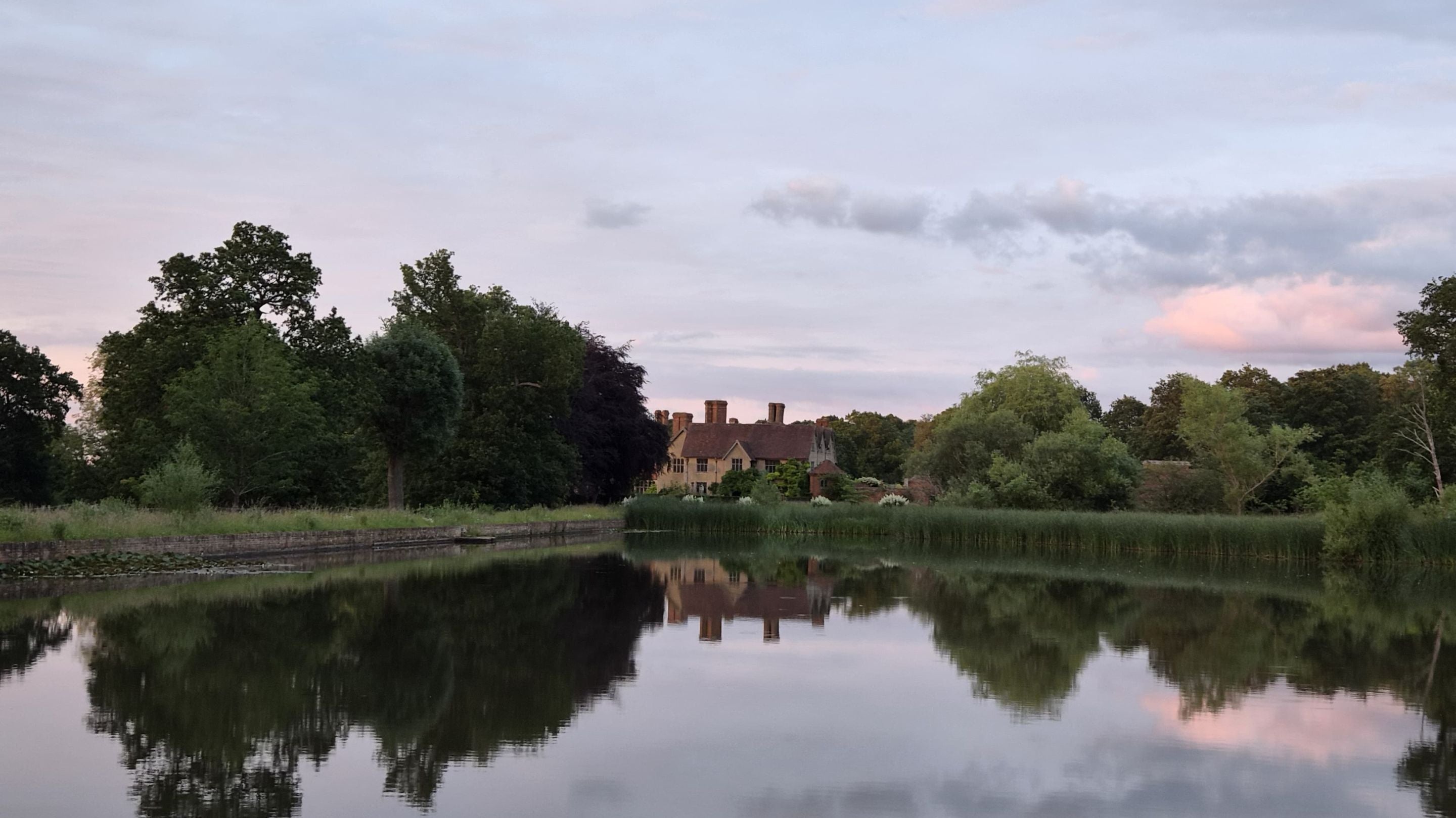 A view of Packwood House, Warwickshire, taken across the lake
