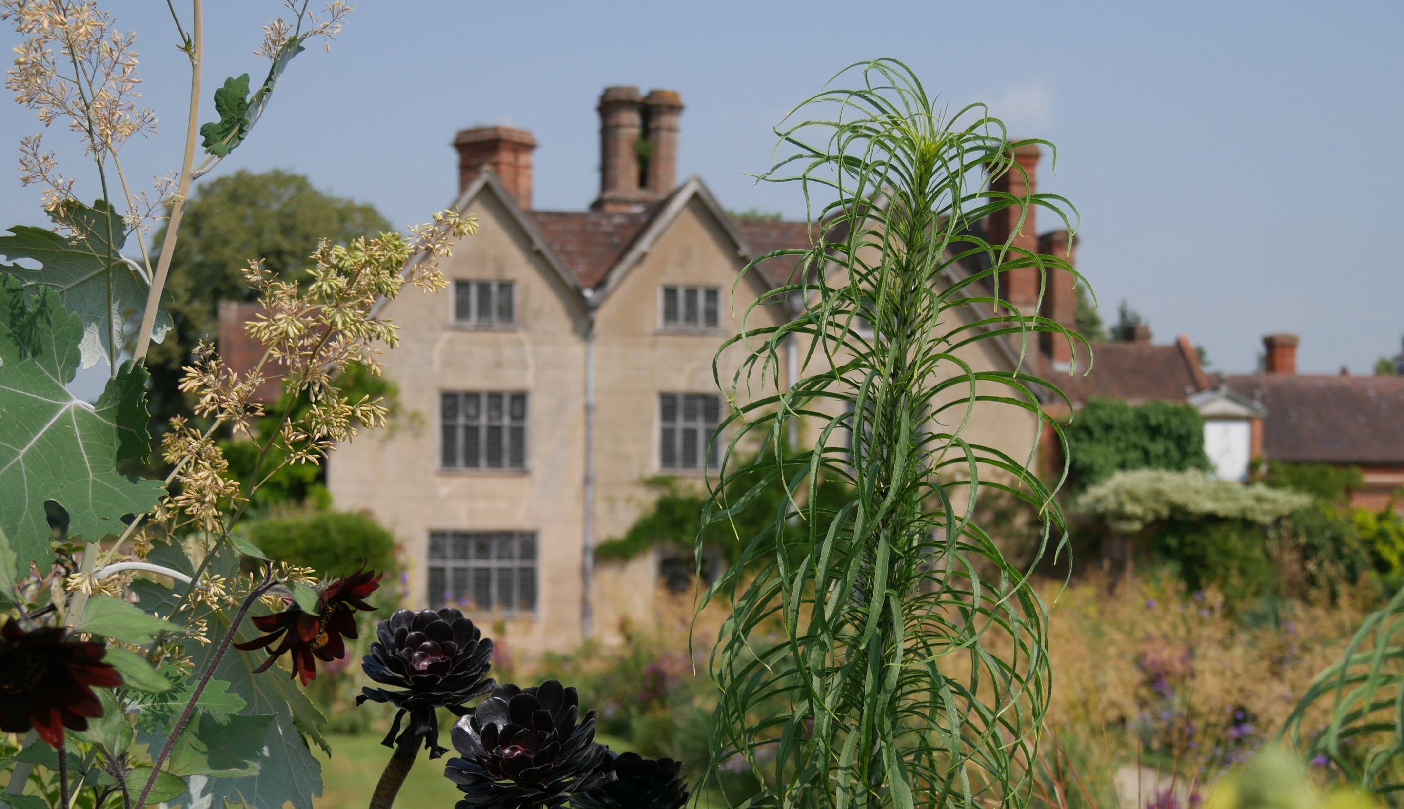 Packwood view of house from garden in summer Warwickshire