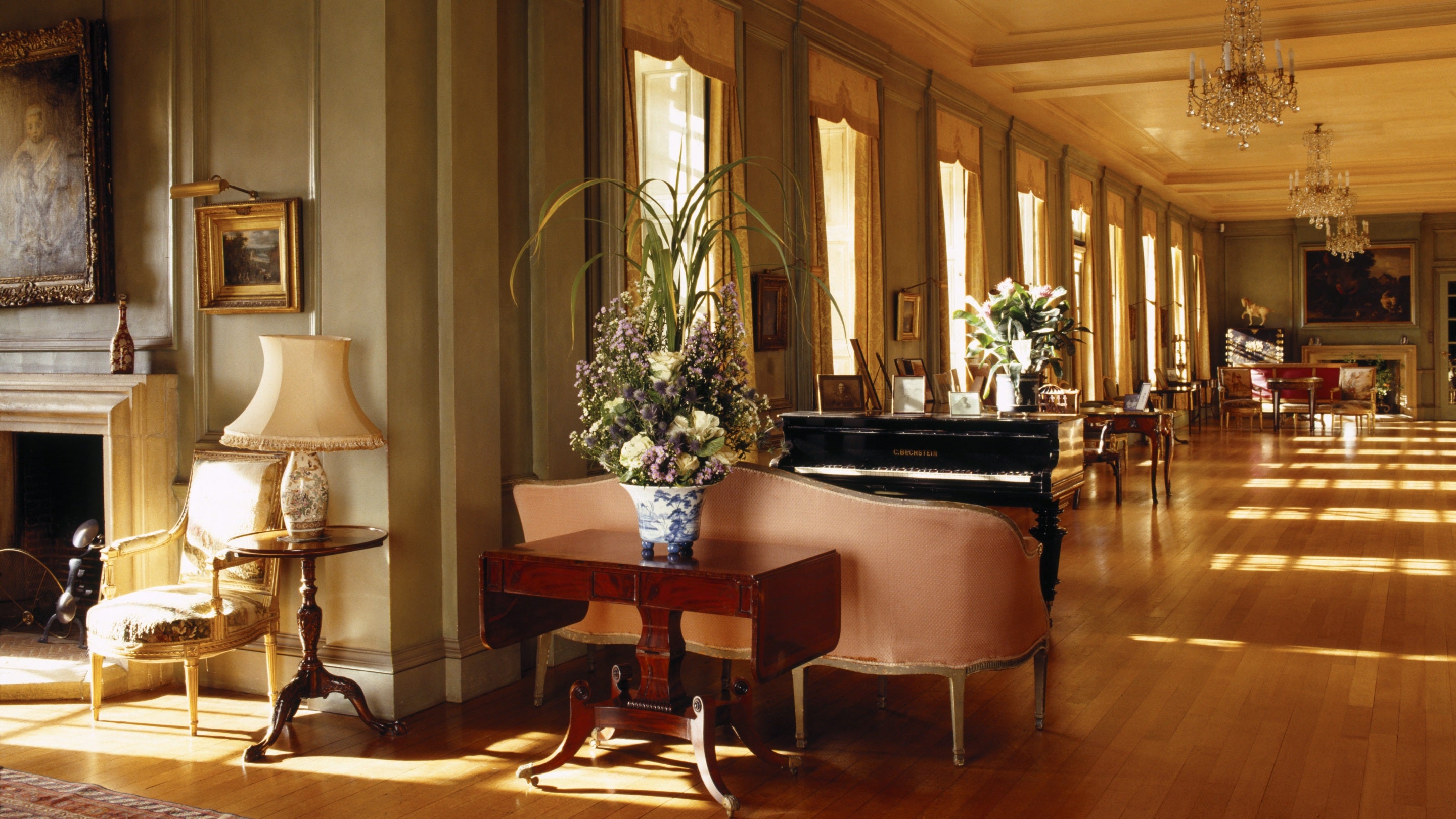Inside the Long Gallery at Upton House, Warwickshire, with its floor-to-ceiling windows and 18th-century English furniture.