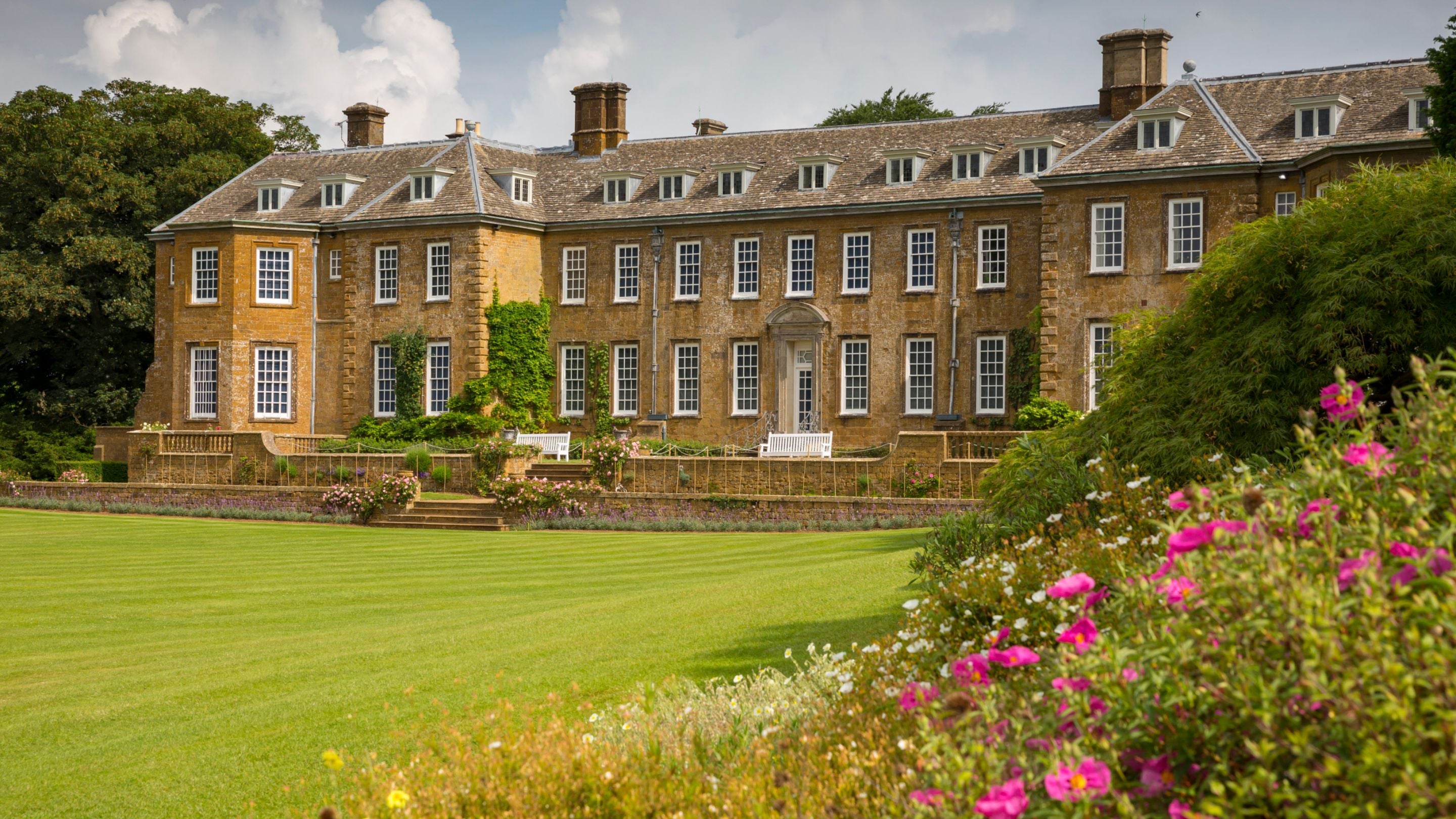 The south garden with balustraded terrace, and sweeping lawn at Upton House and Gardens, Warwickshire