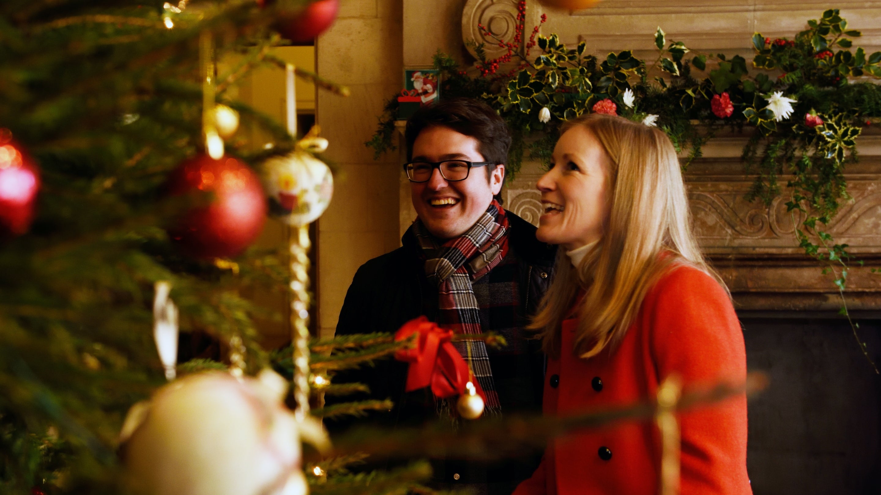 Visitors looking at the Christmas tree decorations at Upton House and Gardens, Warwickshire