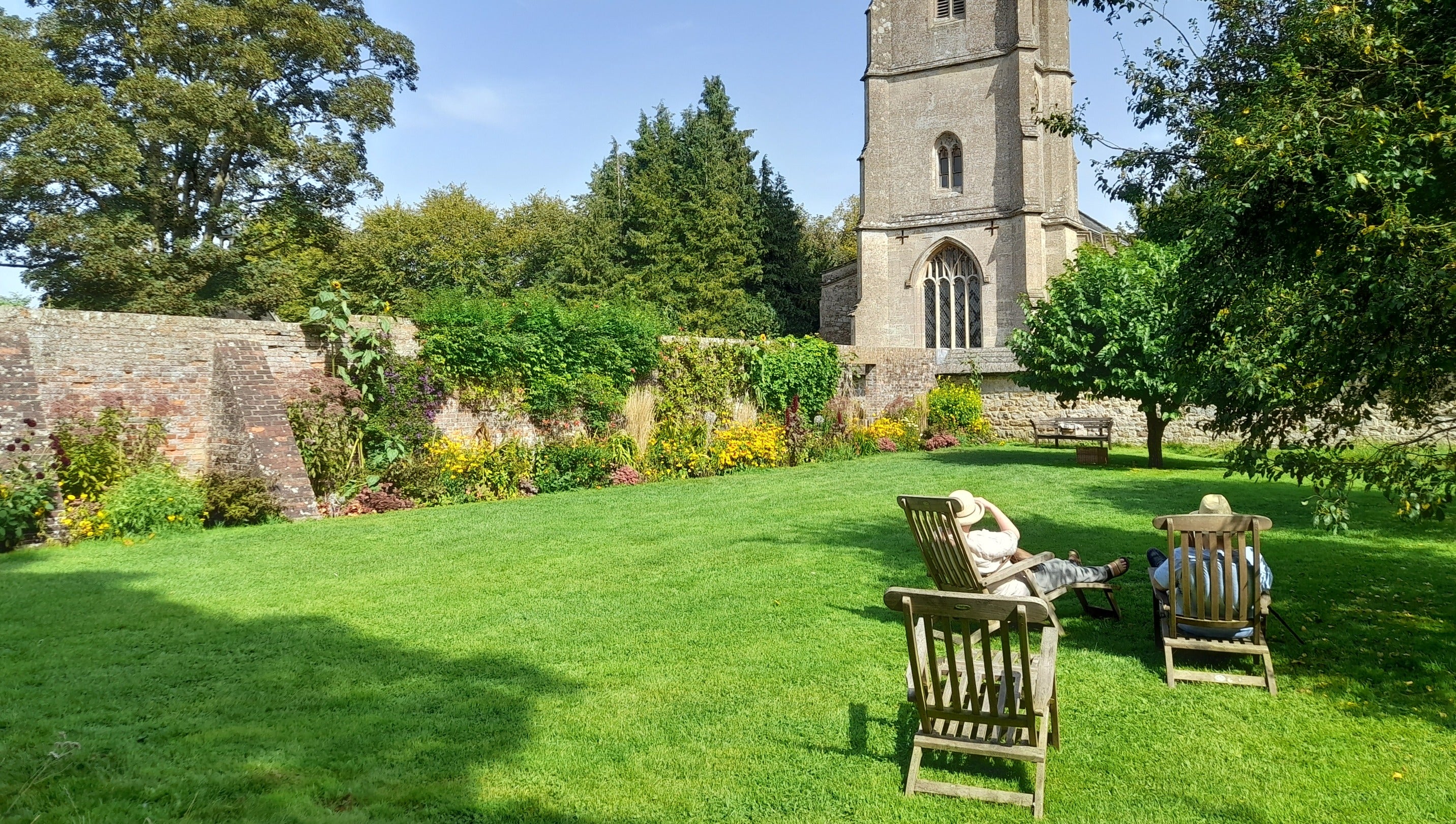 The relaxing Church Garden, green lawns and colour full borders