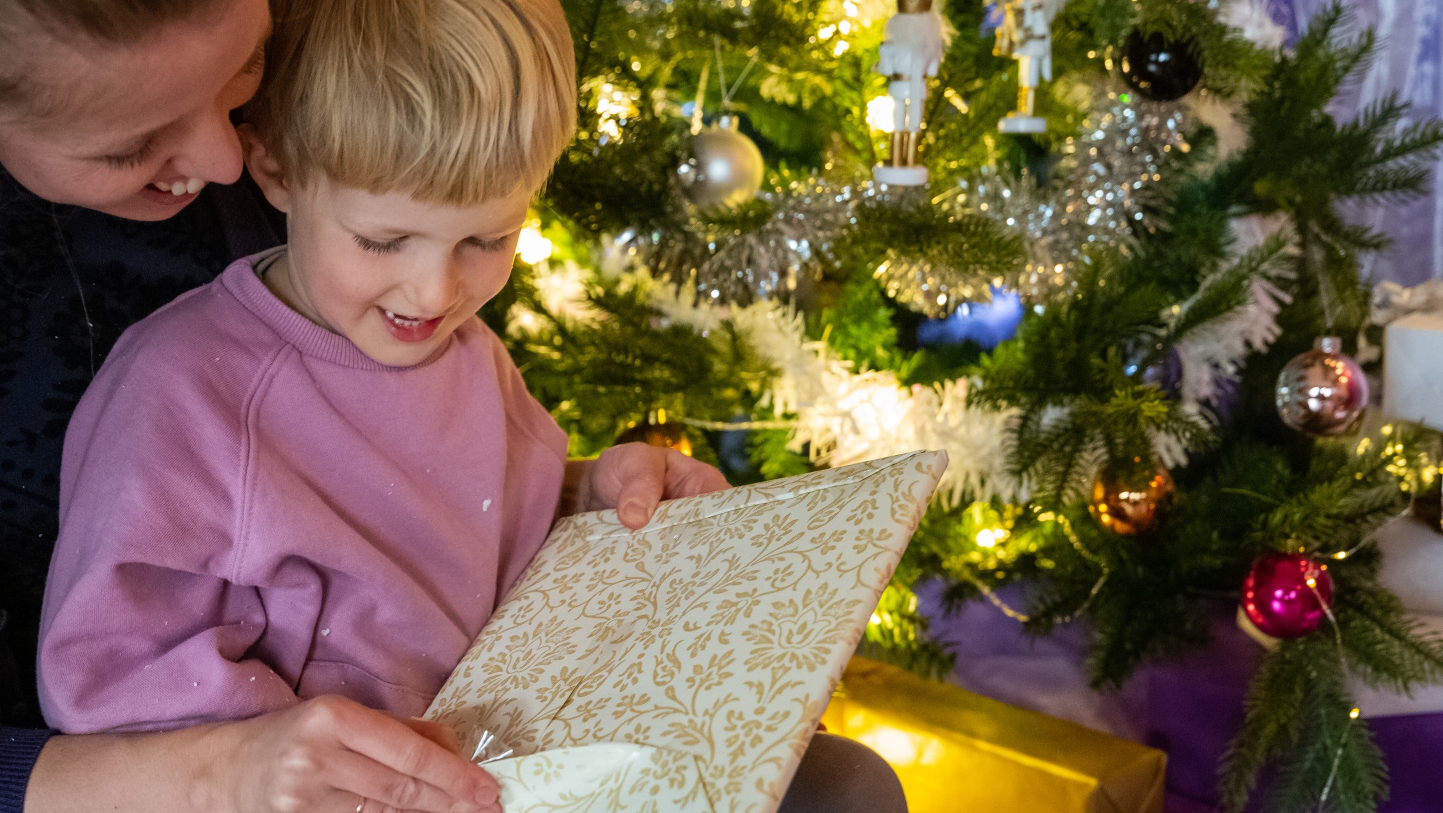 A child opening a Christmas present