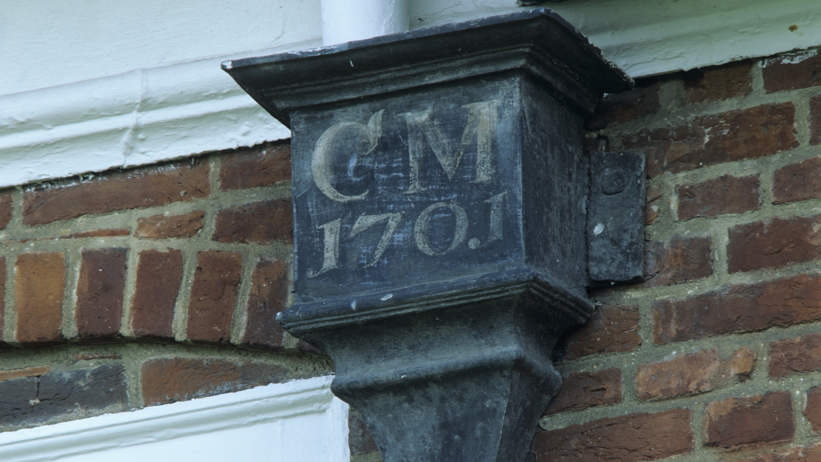 Detail of the initials 'CM' and the date 1701 on a lead rain water head on the front façade at Mompesson House, Salisbury, Wiltshire.
