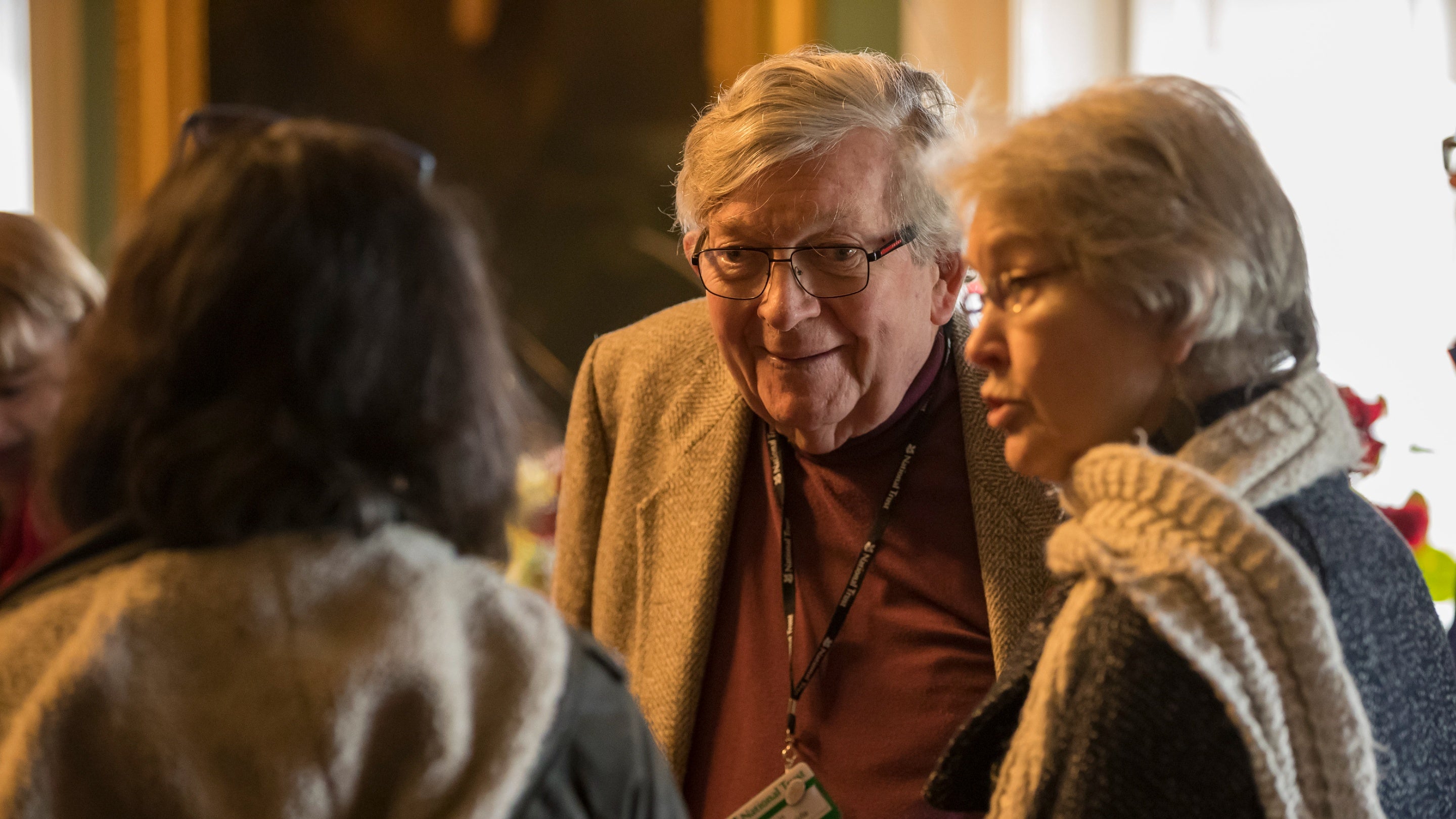 A volunteer National Trust guide talks to visitors