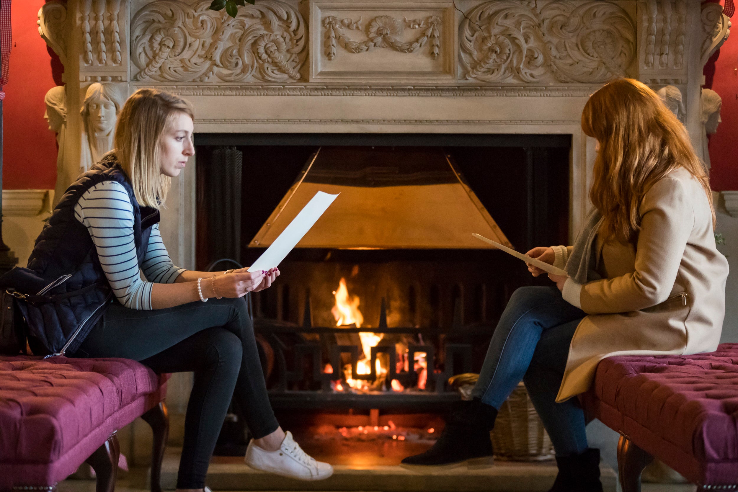 Visitors in front of the Entrance Hall fire at Stourhead house.