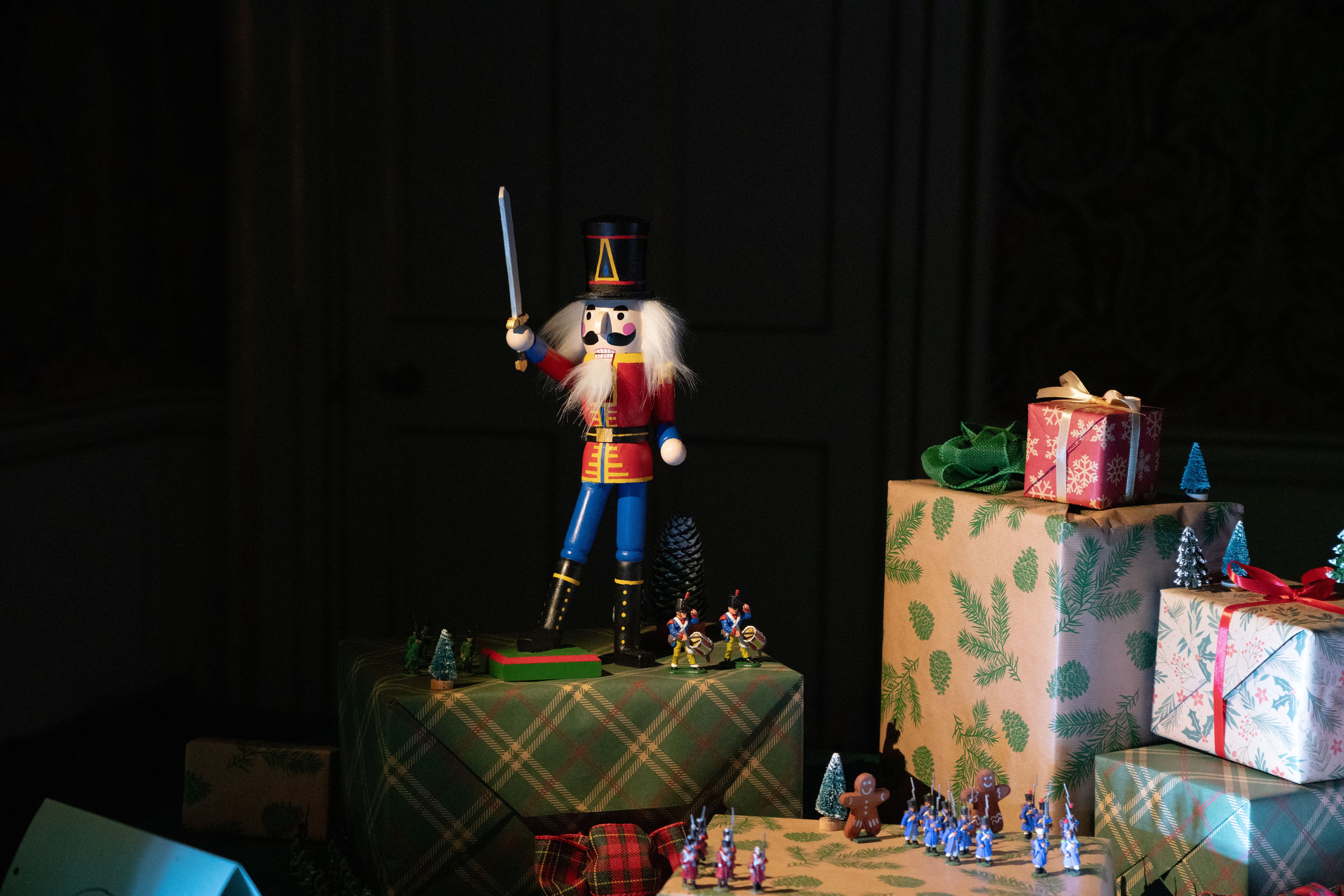 A nutcracker amongst a pile of presents