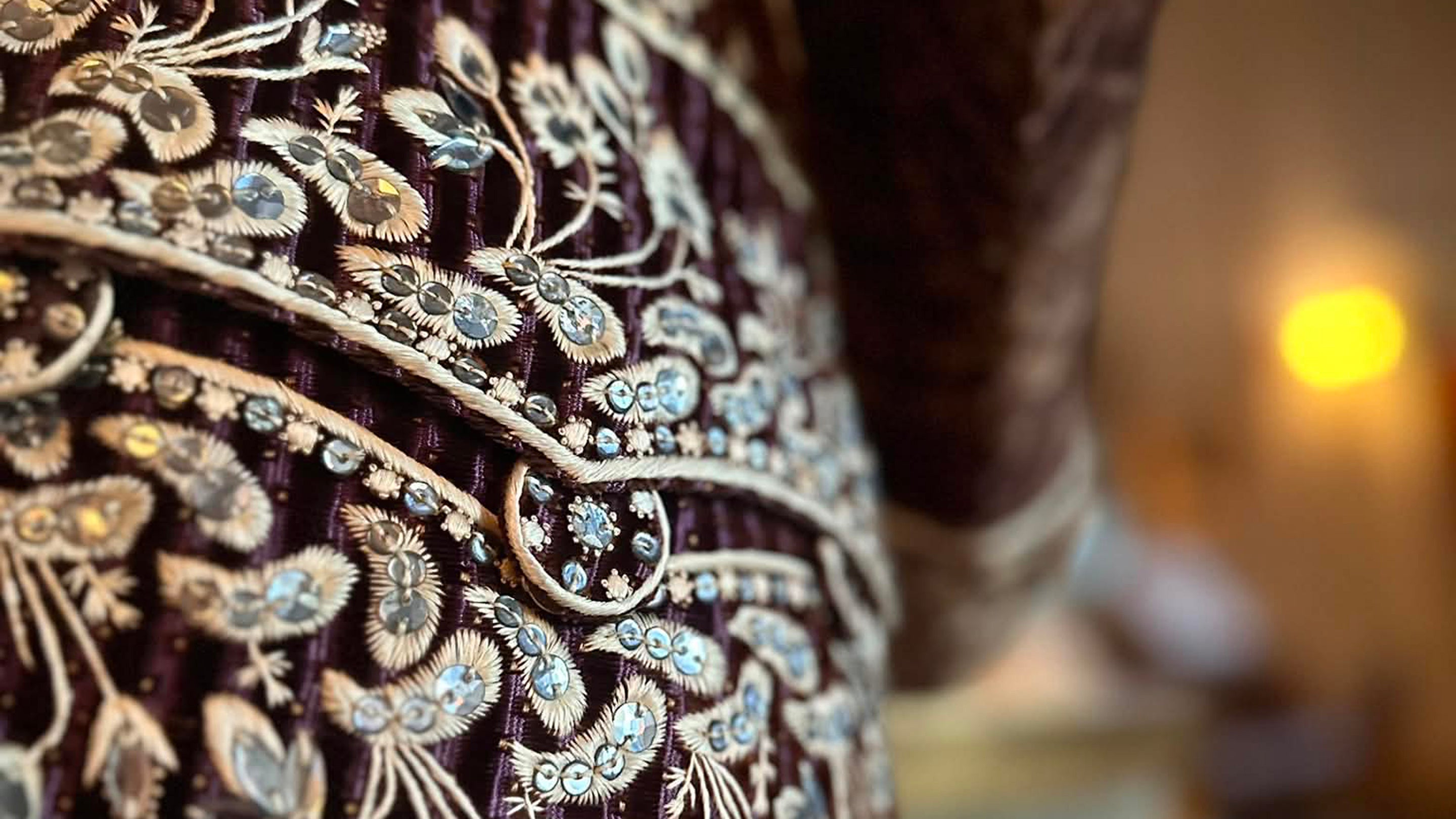 A close up of rich embroidery on a velvet coat
