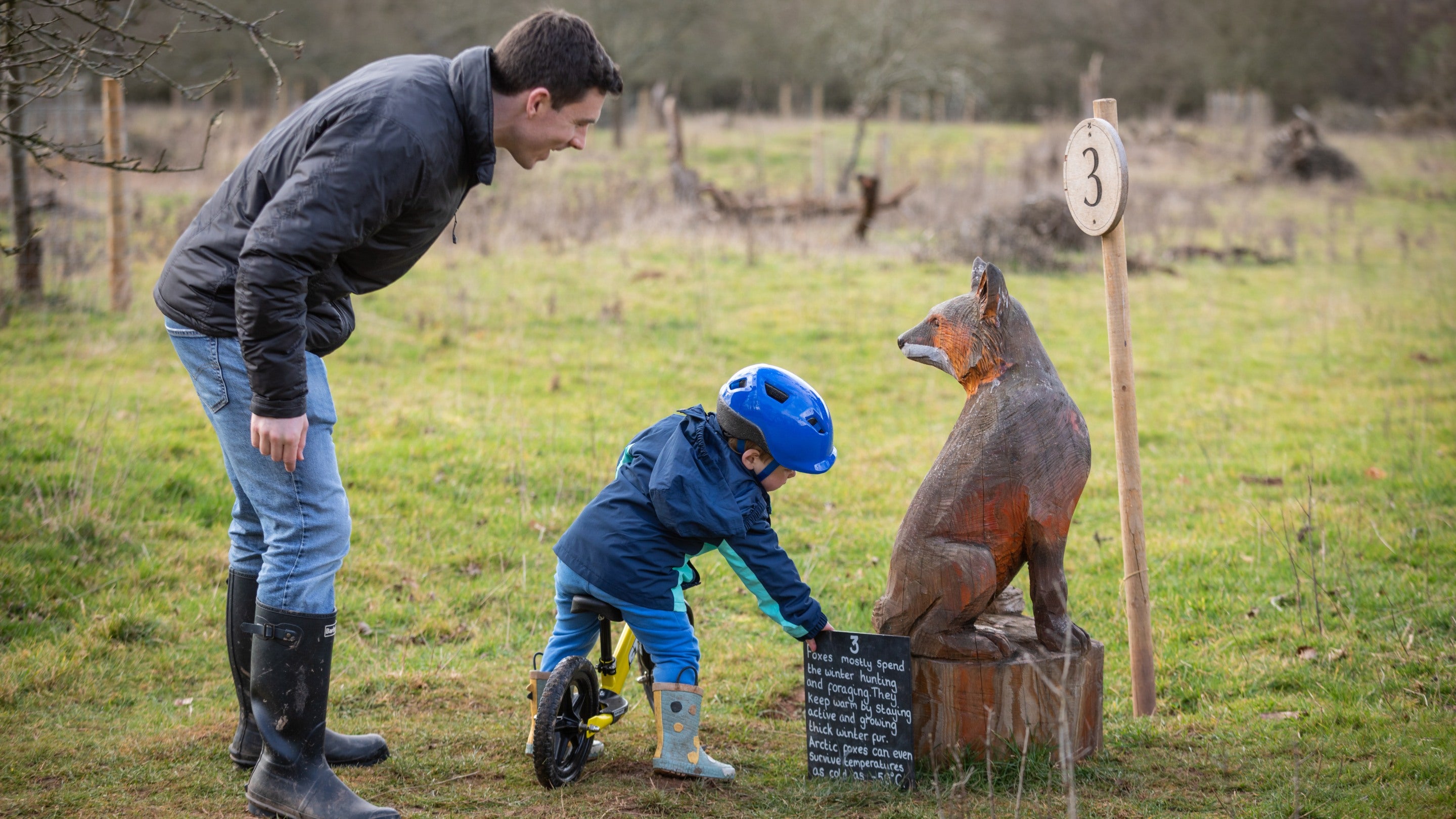 Visitors take a closer look at an animal carving