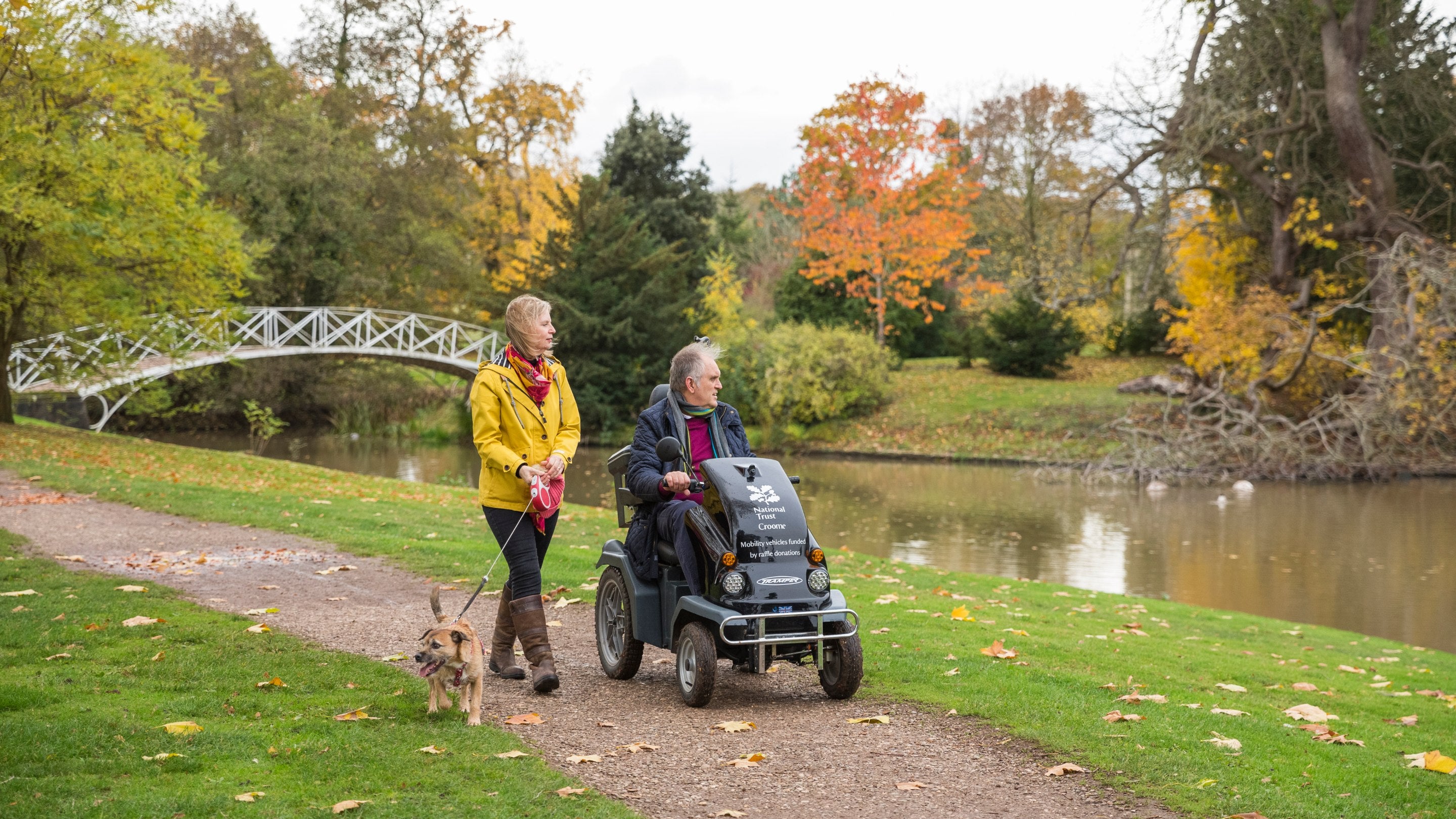 Visitors exploring the parkland in autumn at Croome, Worcestershire