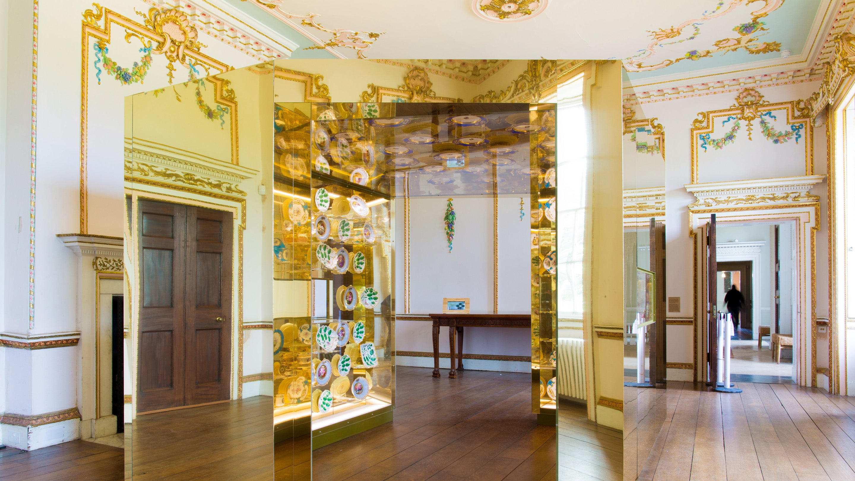 2 metre high 'Golden Box' installation with a reflective cube whose interior is encrusted with exquisite pieces of Meissen, Worcester and Sevres porcelain from Croome’s collection.