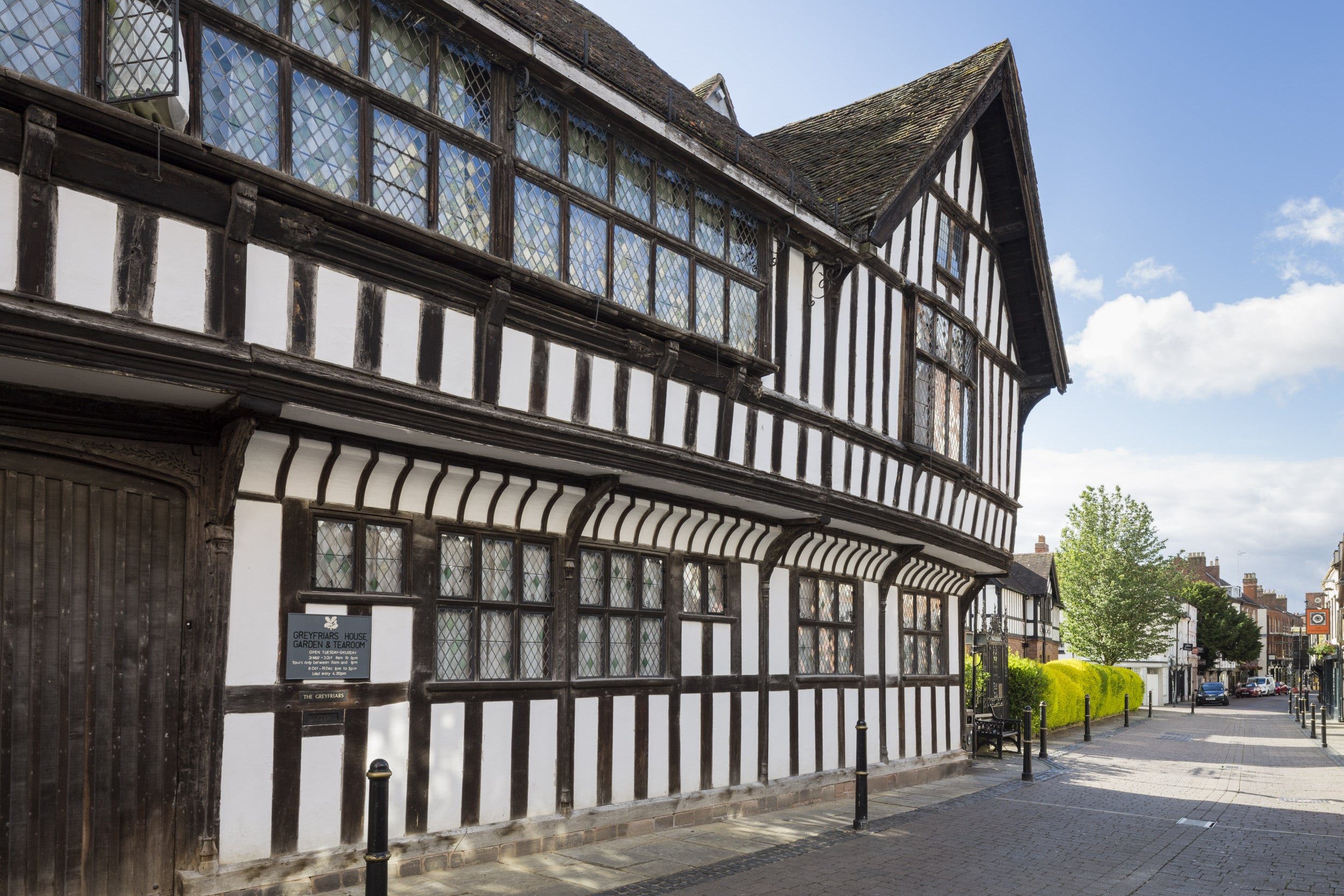 A view of the exterior of black and white timber framed Greyfriars House from Friar Street