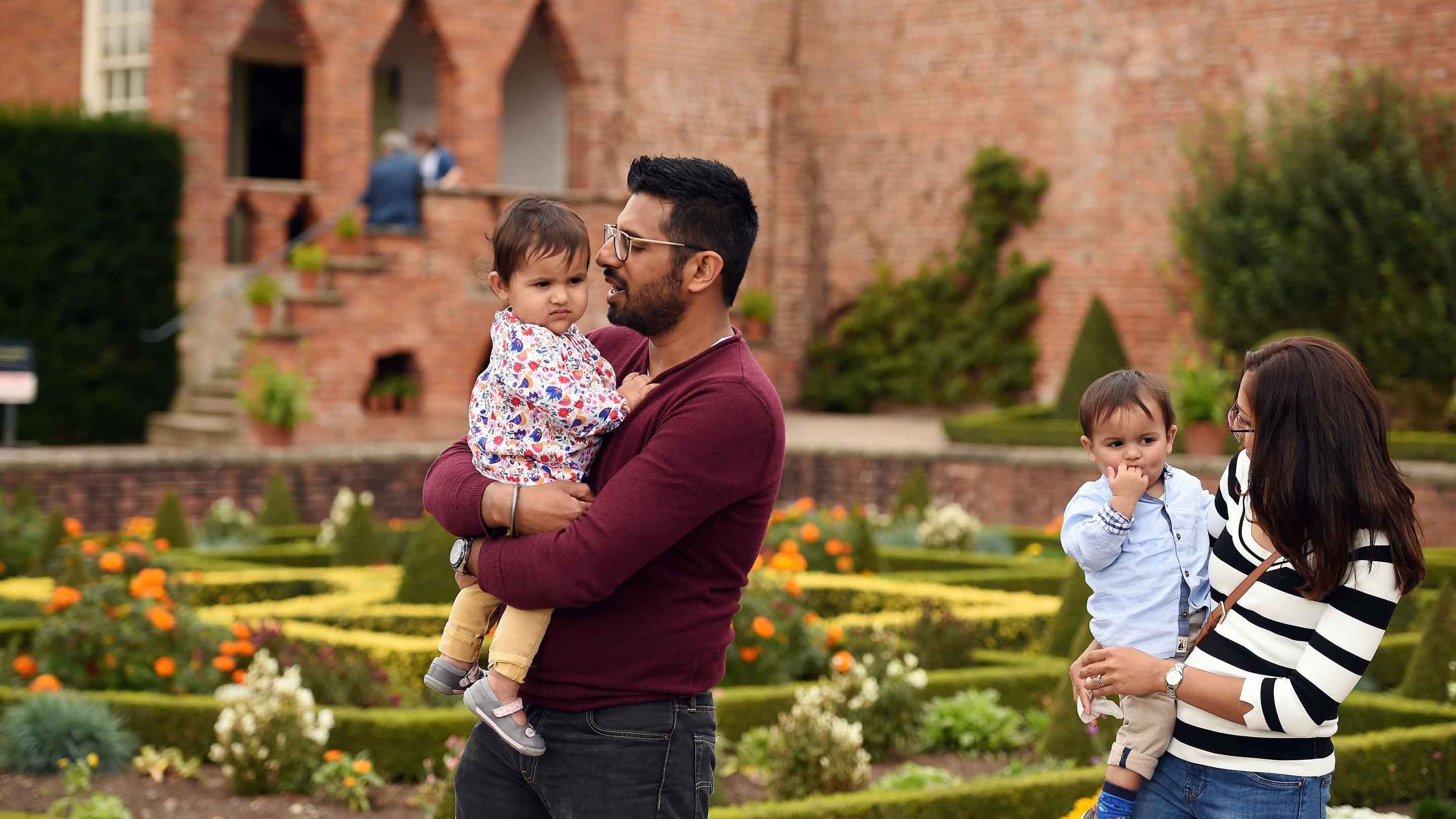 A family in the garden on a day out at Hanbury Hall and Gardens, Worcestershire