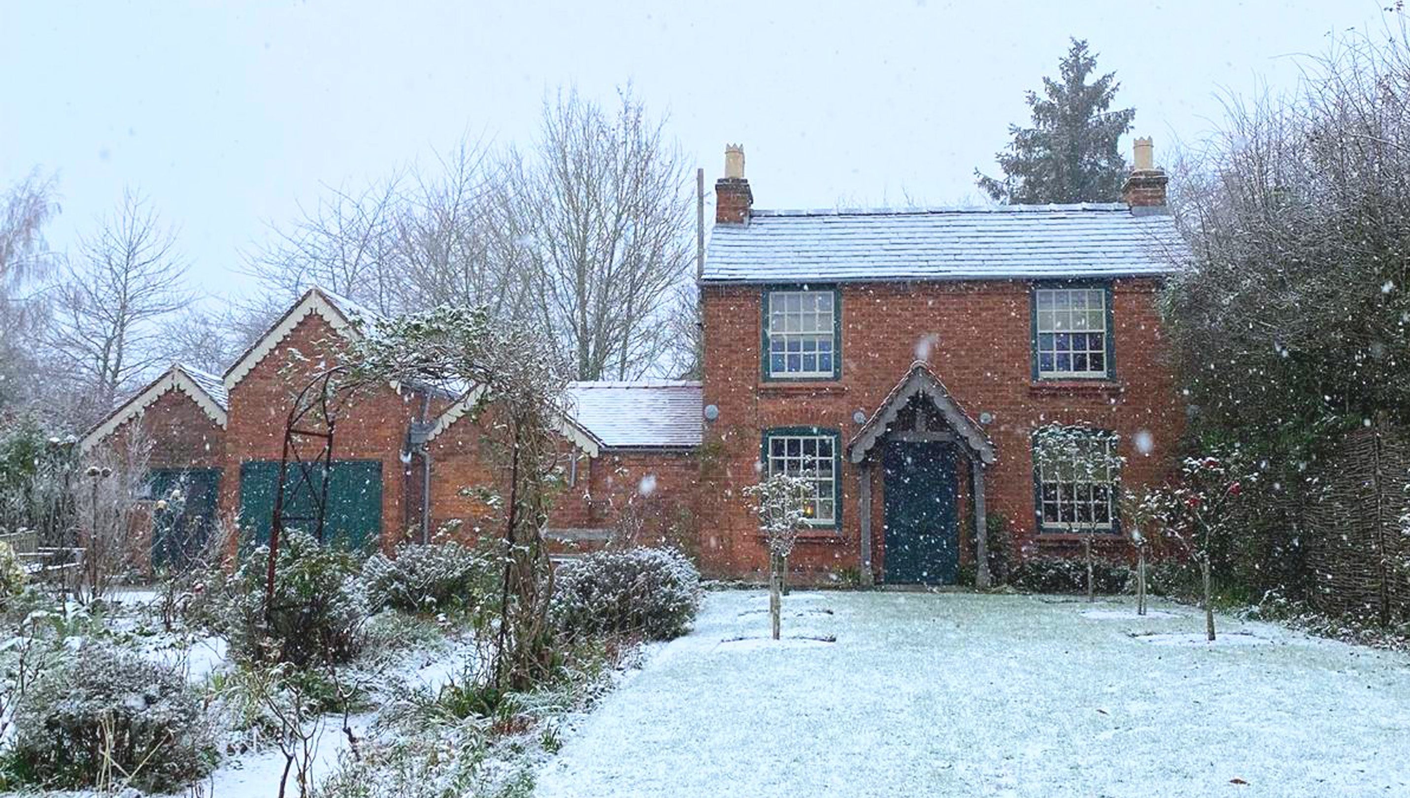 Quaint red brick Victorian cottage and birthplace of Edward Elgar with a blanket of snow