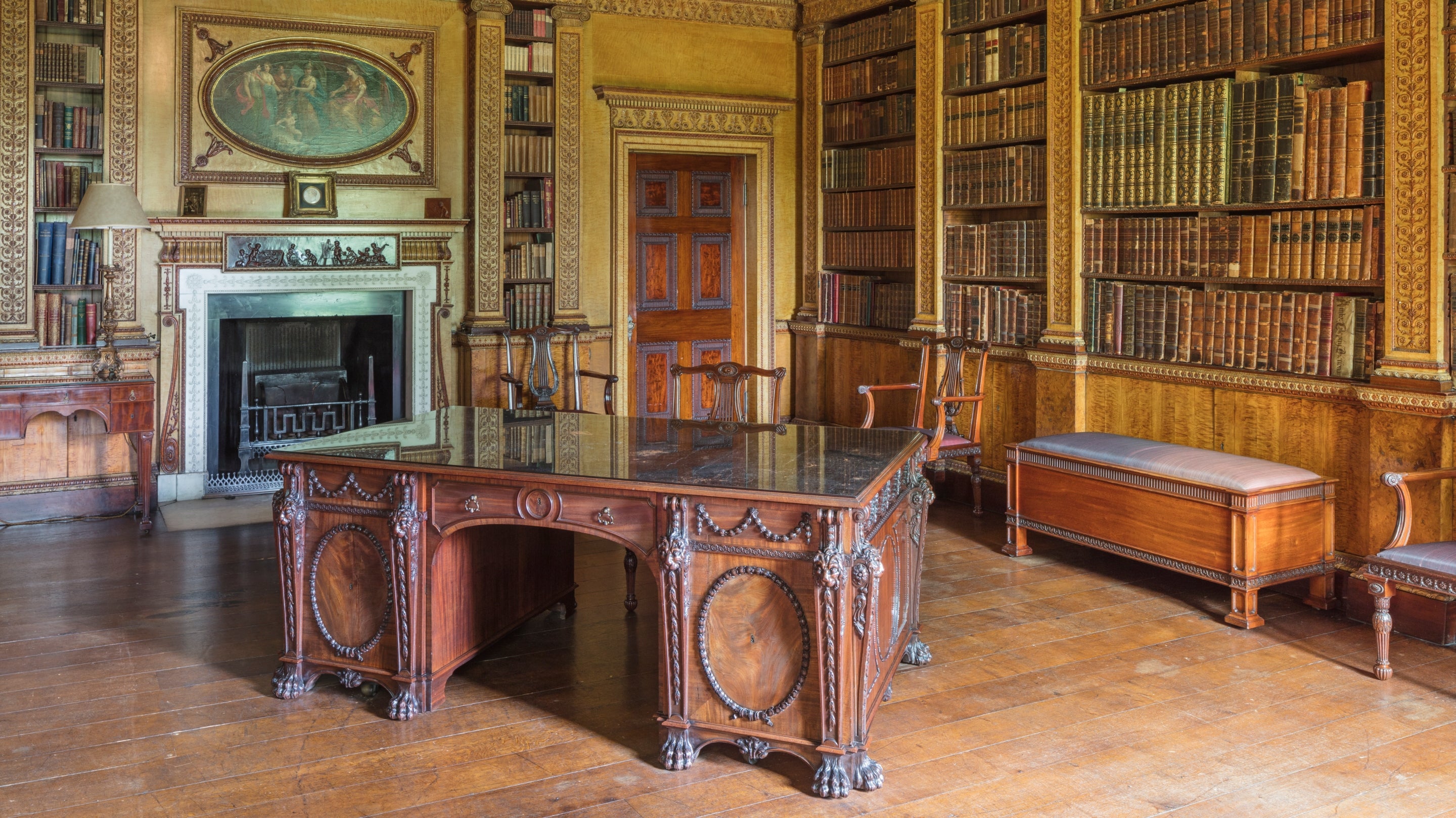 Large wooden desk in the centre of the library room at Nostell