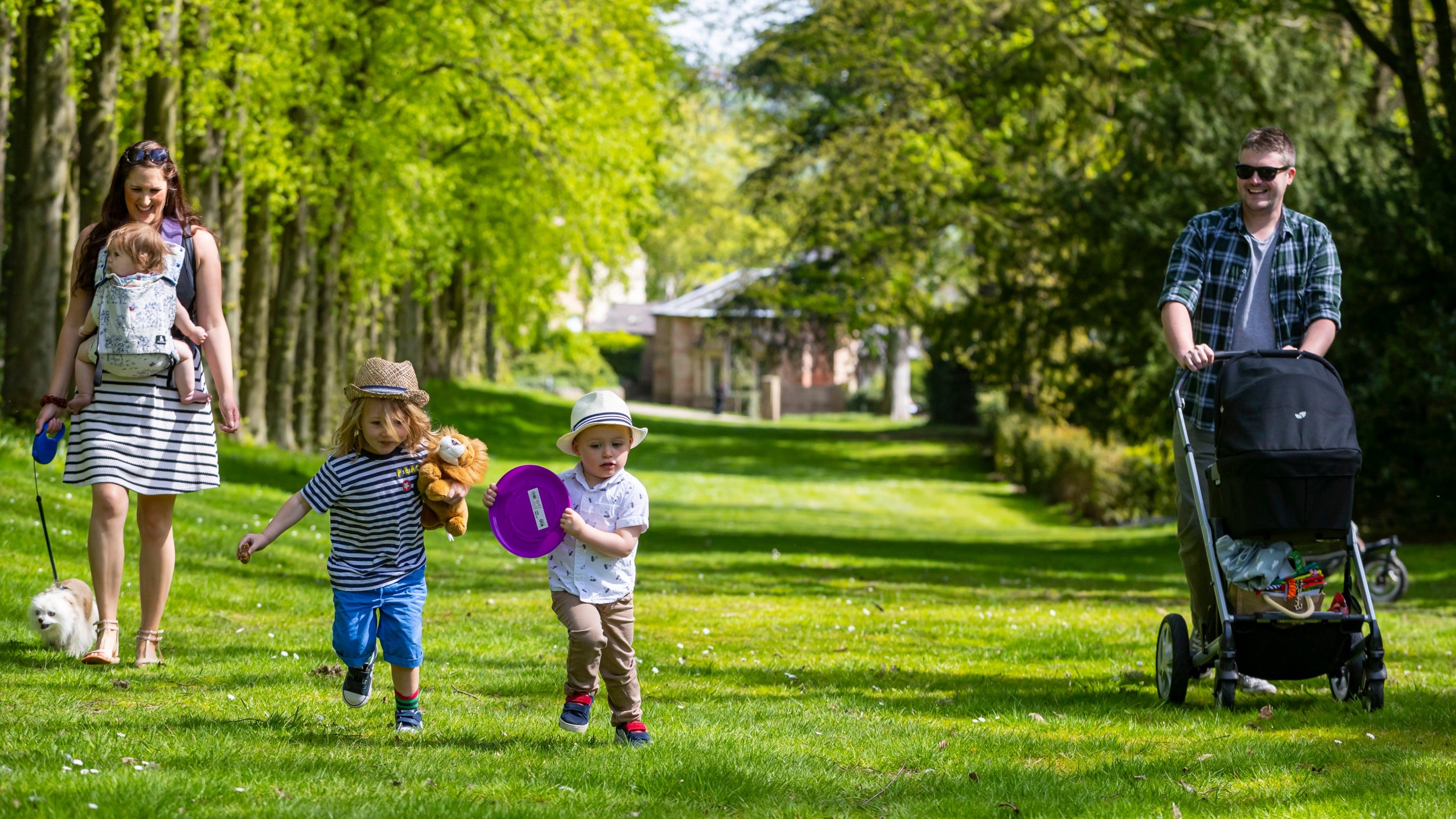 A family enjoying a walk with their dog in Wentworth Castle Gardens, South Yorkshire