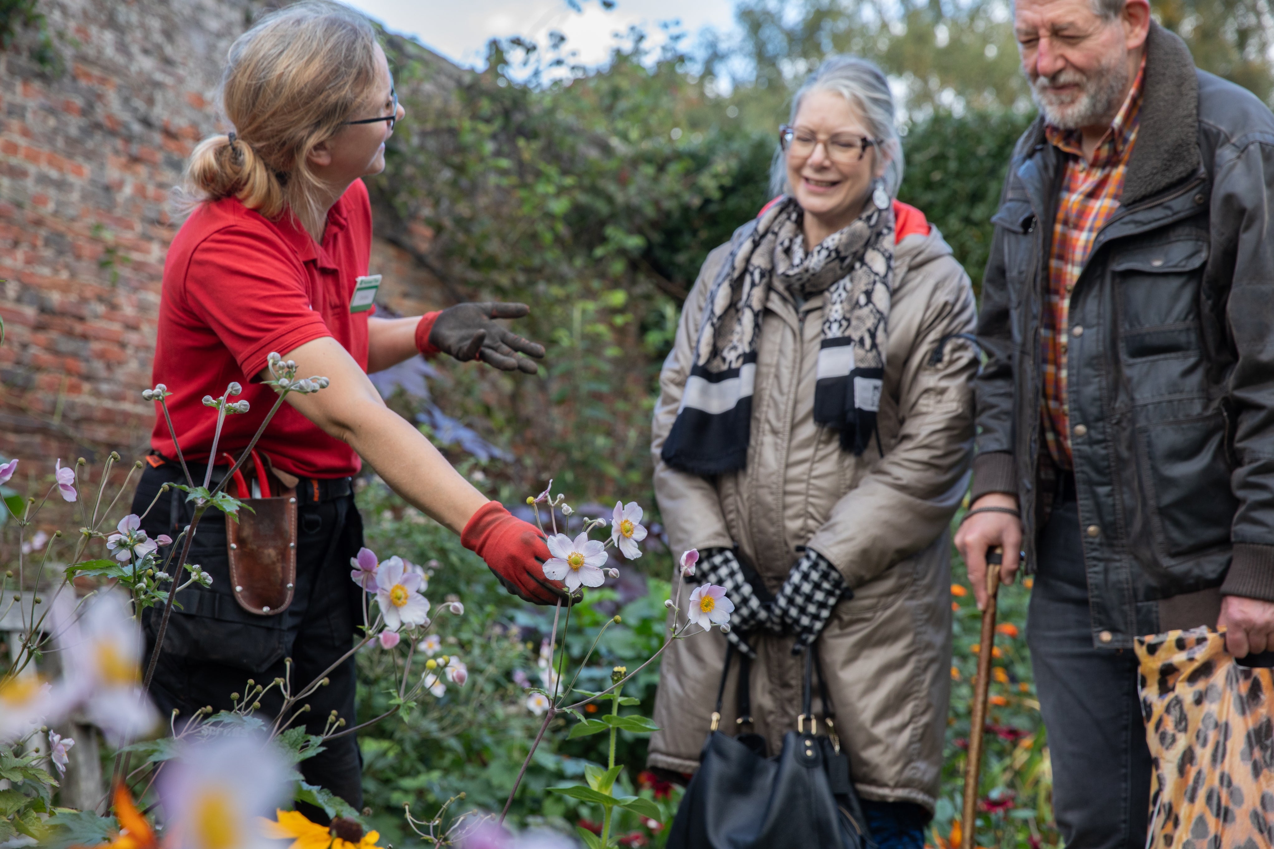 Gardener talking to visitors at the South Border at Beningbrough, North Yorkshire