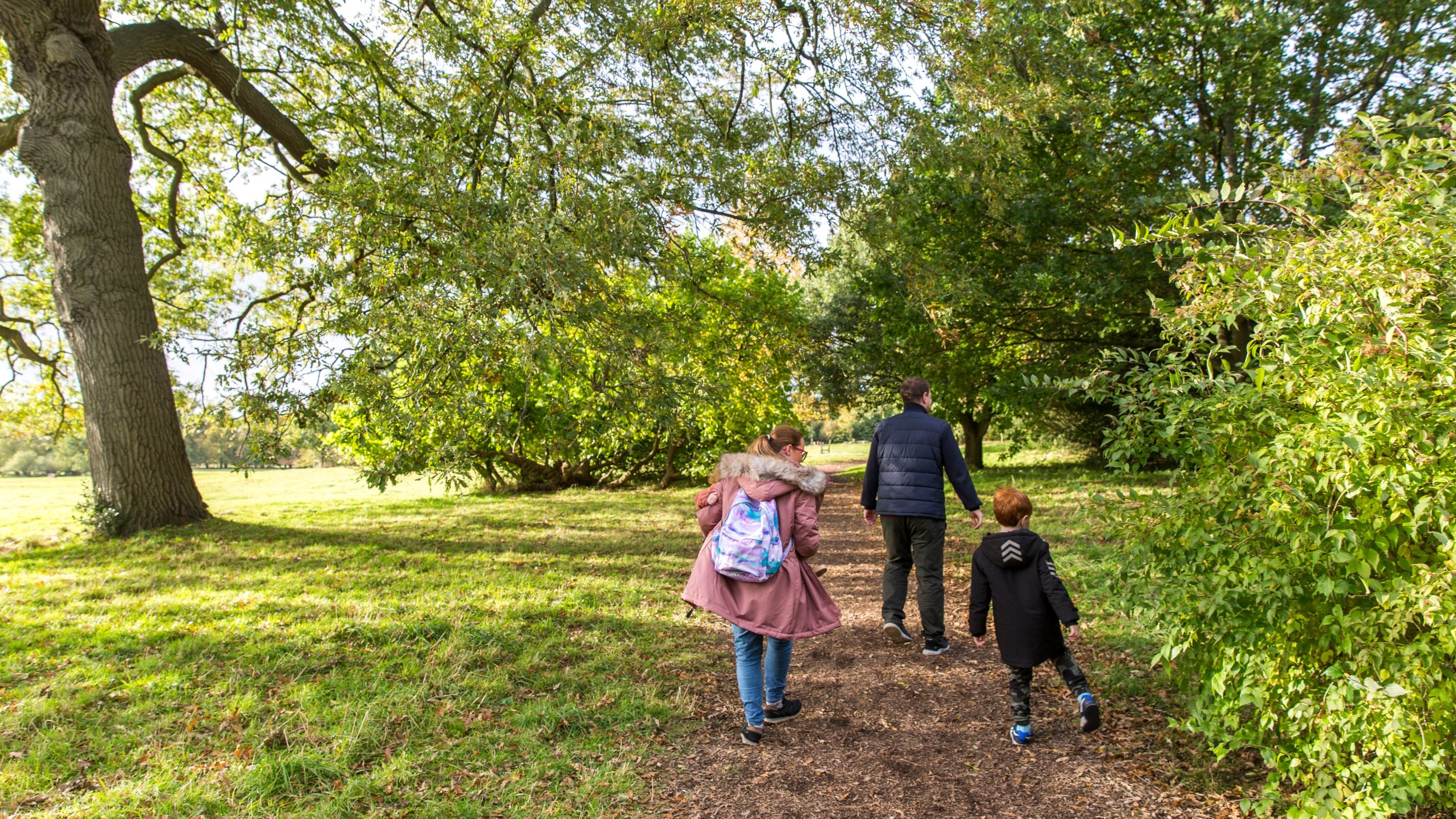 A family walking in the woods at Beningbrough, North Yorkshire