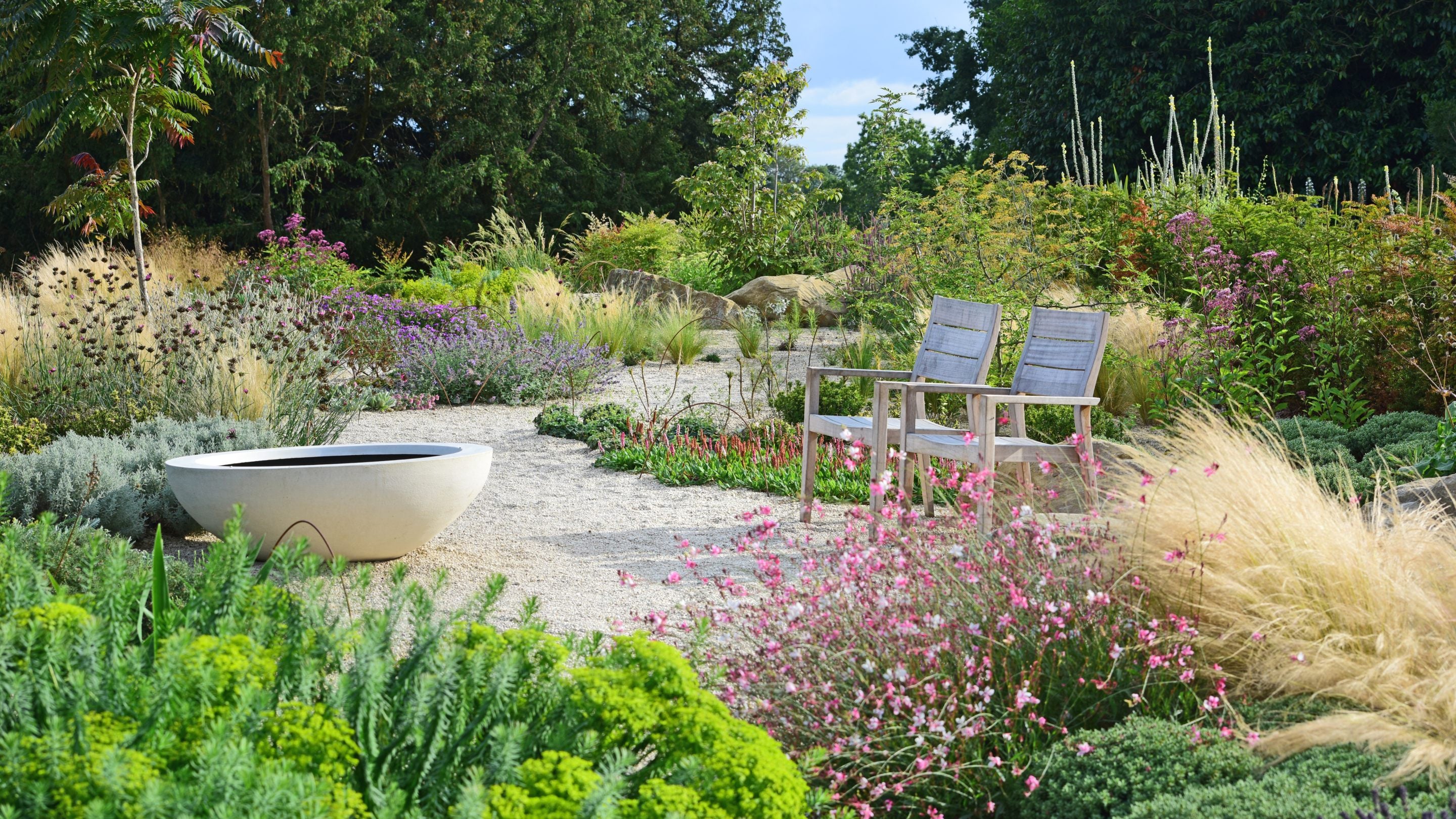 Gavel paths, lots of different planting and two wooden chairs