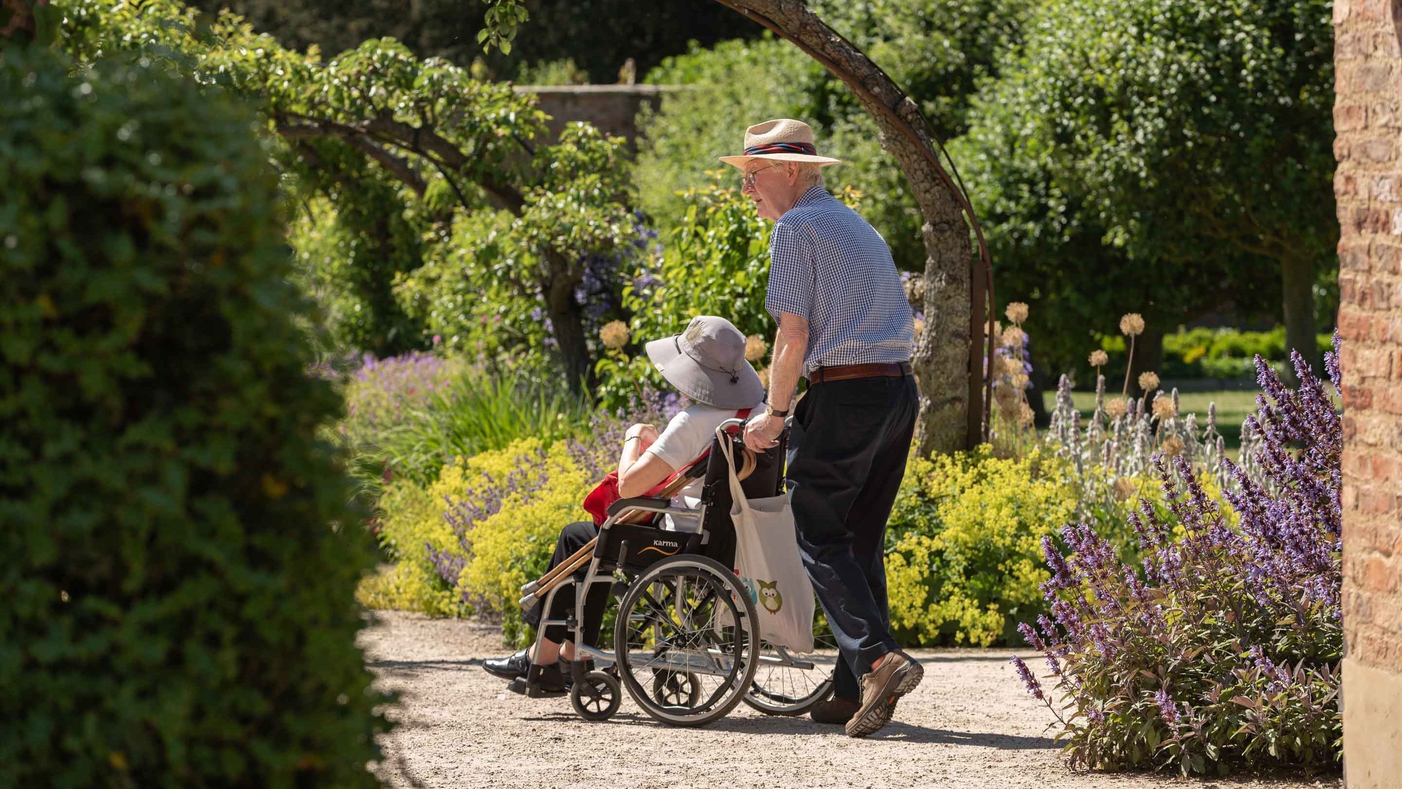 Visitors explore the Walled Garden in summer at Beningbrough Hall and Gardens, North Yorkshire