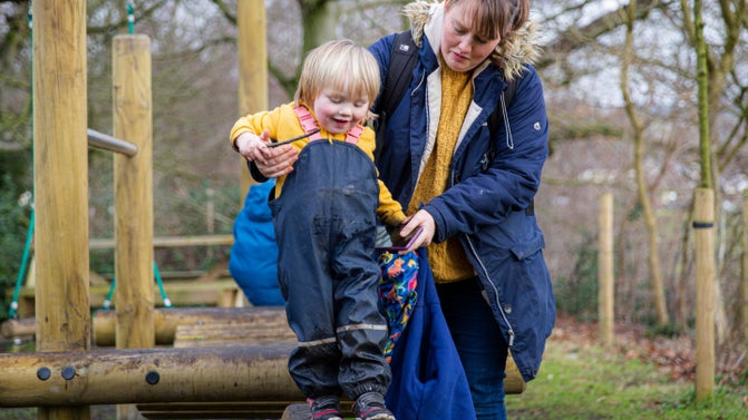 Family playing on the trim trail at East Riddlesden Hall