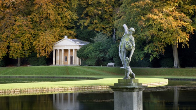 The lead statue of Bacchus in front of the Temple of Piety at Studley Royal Water Garden, North Yorkshire
