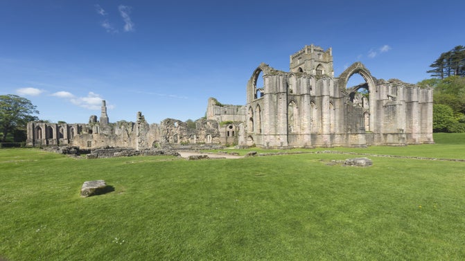 View of the ruins at Fountains Abbey on a sunny day