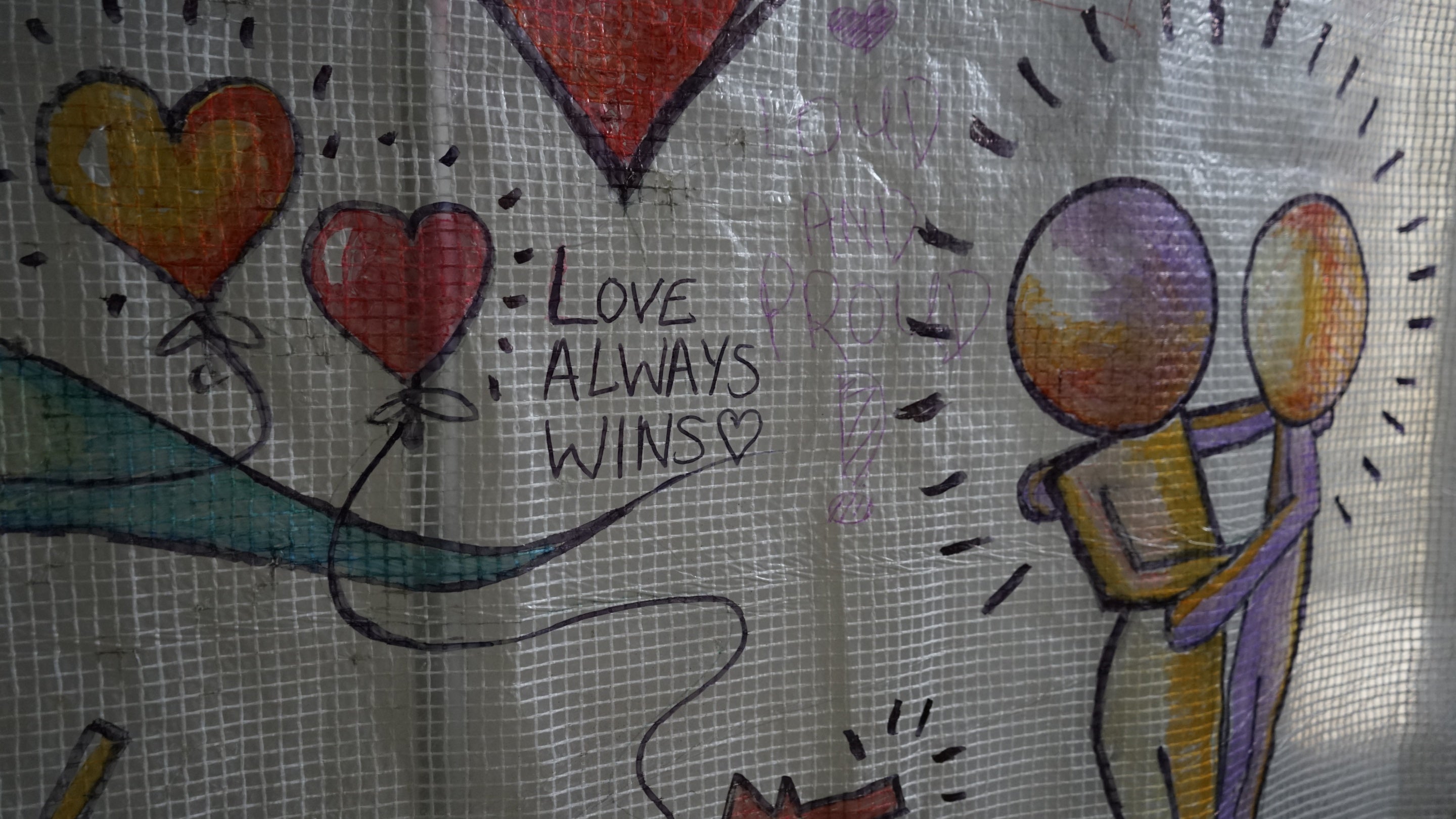 A white tarpaulin covered in artworks