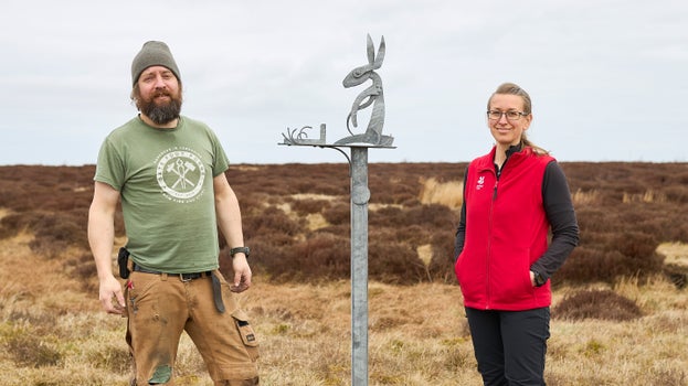 NT Peat specialist Tia Crouch and blacksmith Owen Phillips are shown with metal hare sculpture