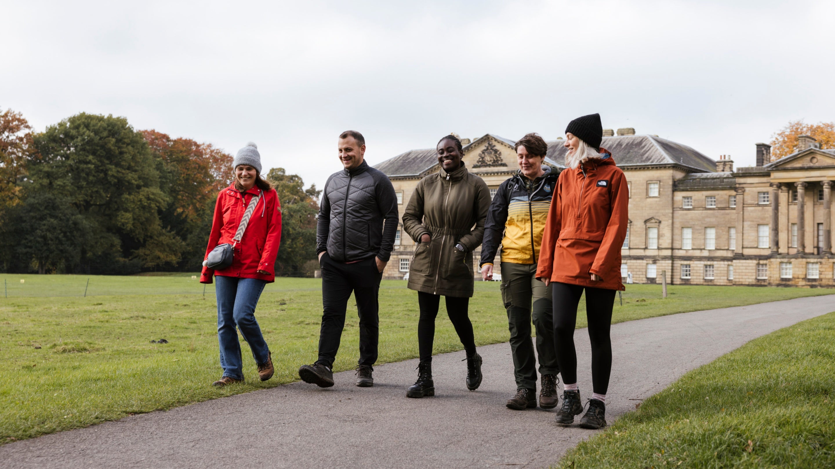 A group of visitors walk in the grounds at Nostell, Yorkshire